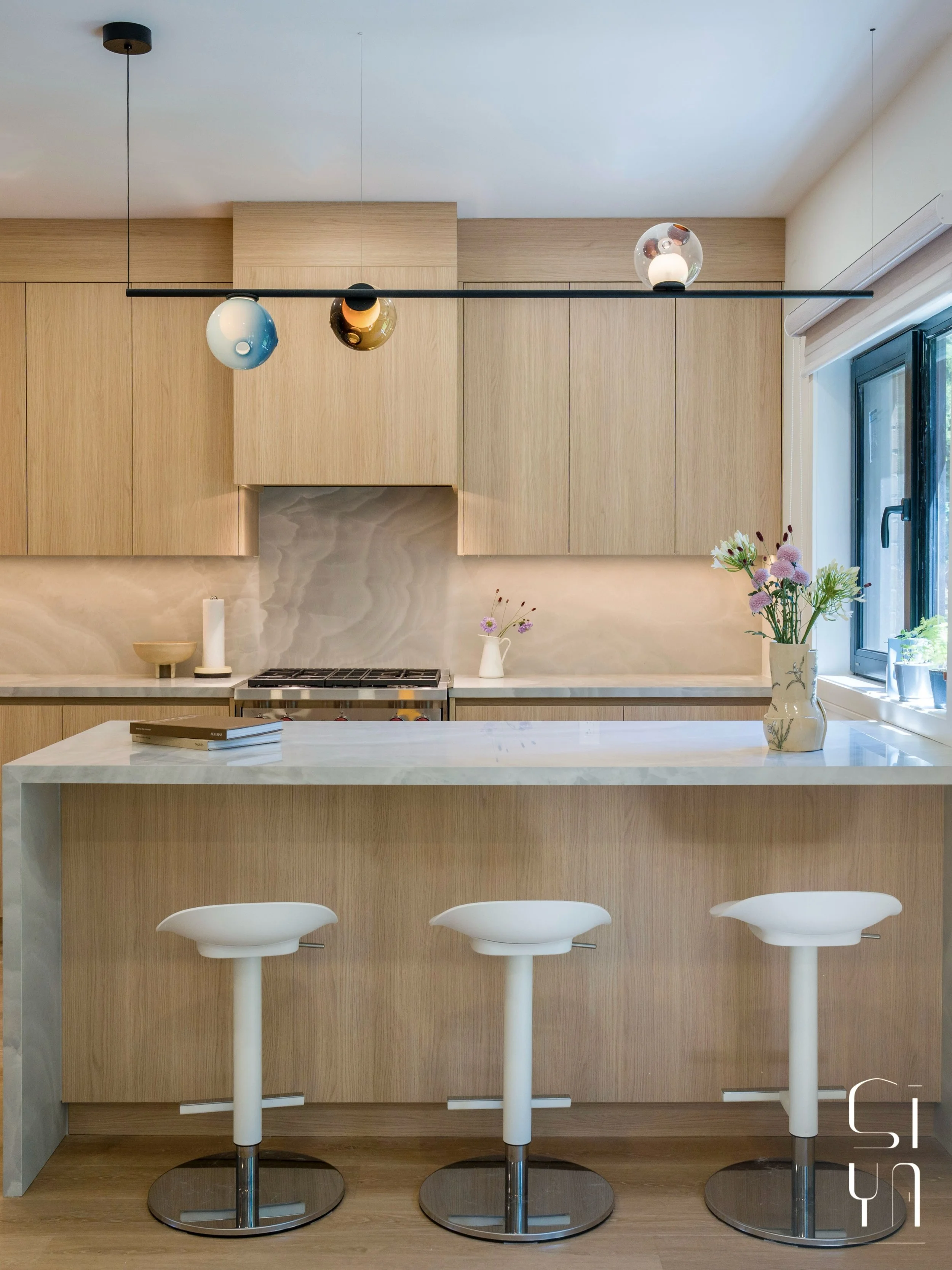The priority for the kitchen renovation for the Maureen project was to create more prep space, storage, and a better workflow.

By reducing the oversized powder room, we were able to expand the kitchen and introduce a functional island. Finished with