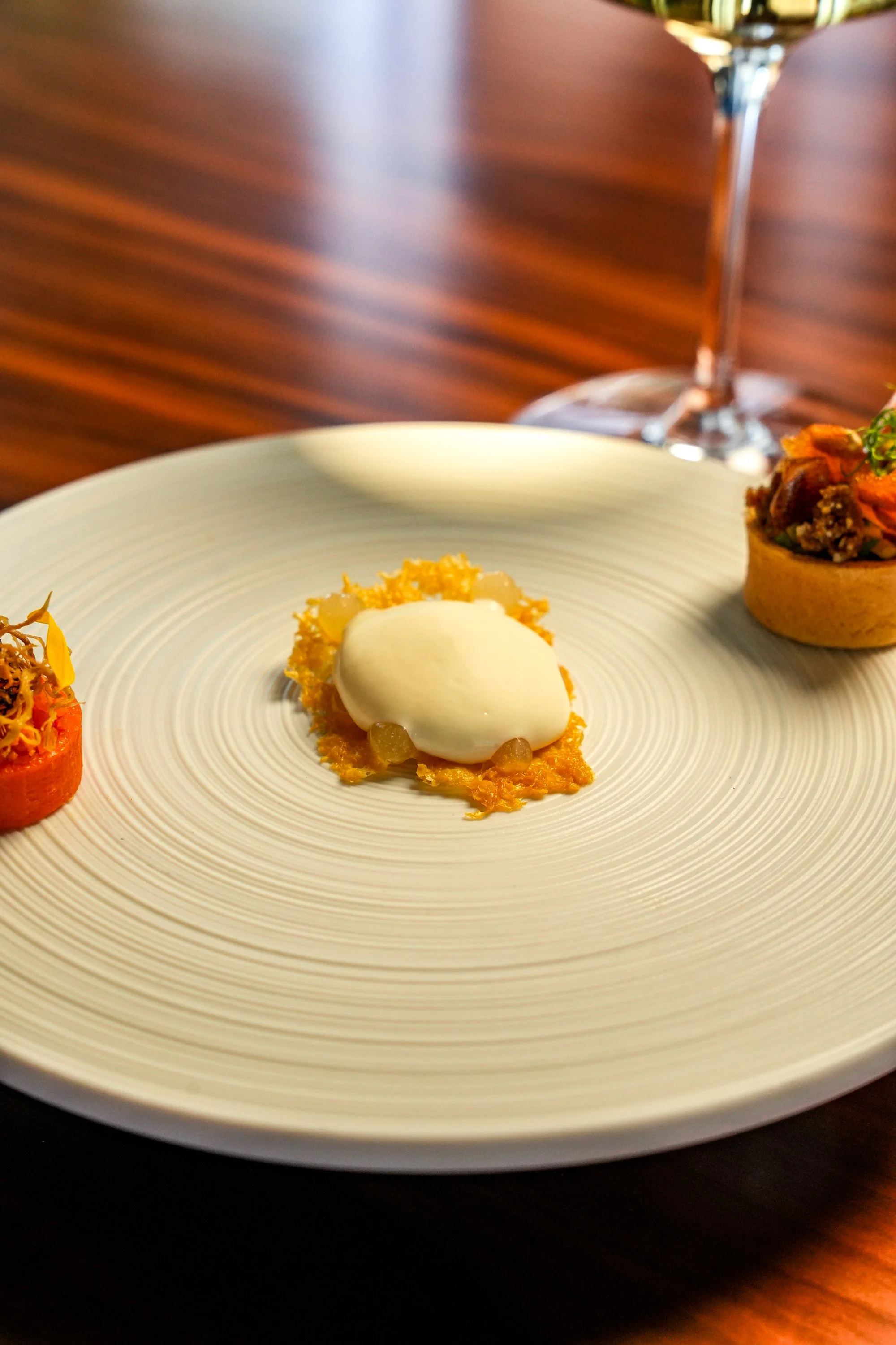 3 small bites on a fine dining white plate