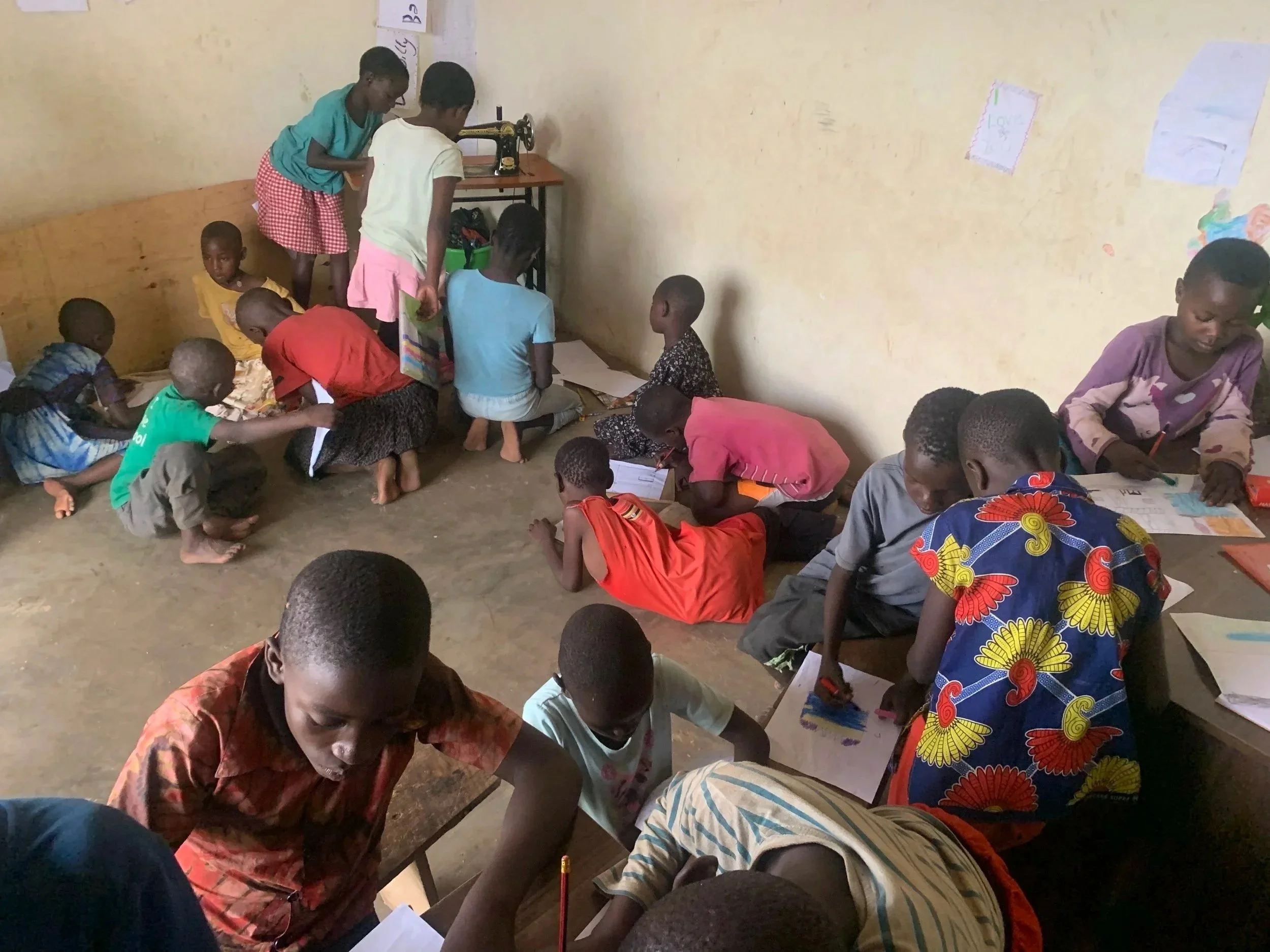 Gunudatid children writing in a team.