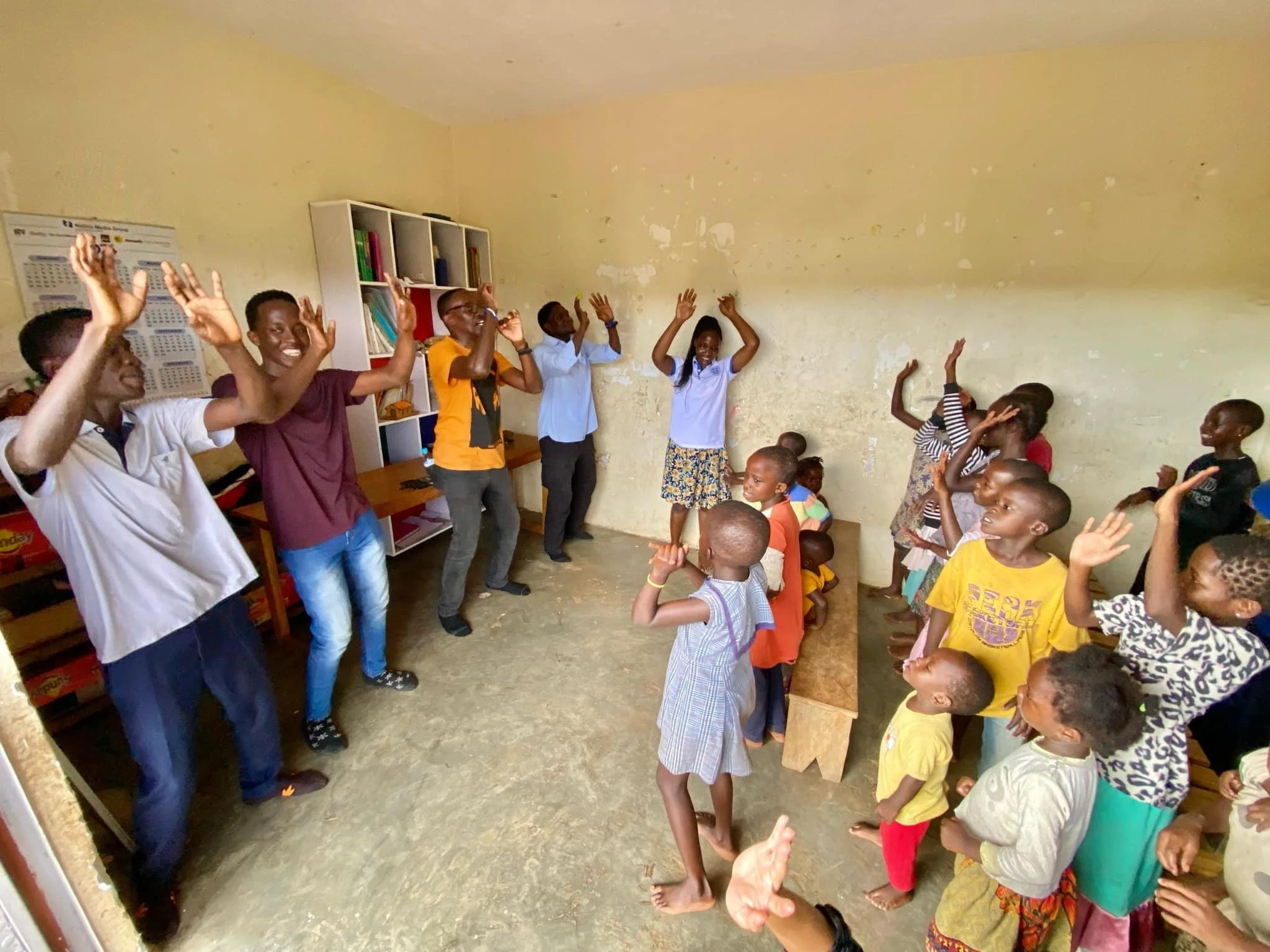 Gunduatid initiative children with guests lifting up their hands