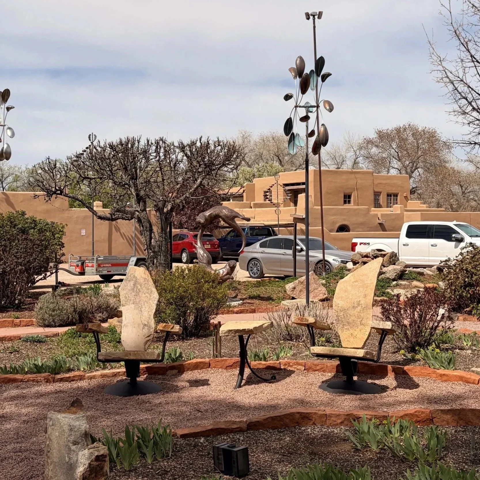 Stone furniture deep set chairs hand sculpted by Garry and Jennifer Carmack of Stone2Furniture. Set in the gardens of a Canyon Road Gallery, The Wiford Gallery in Santa Fe, New Mexico