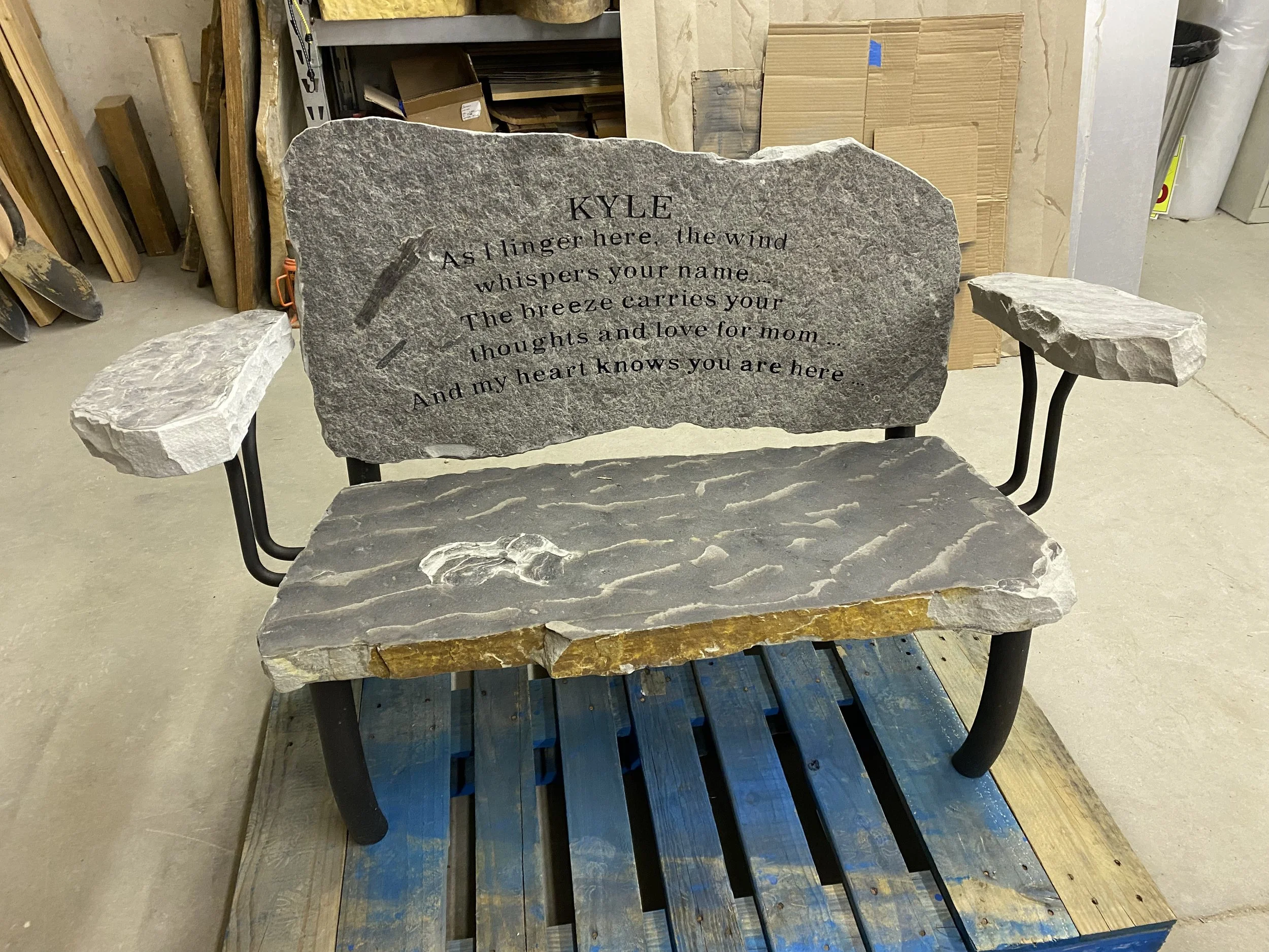 Stone memorial bench with inscription, indoor setting