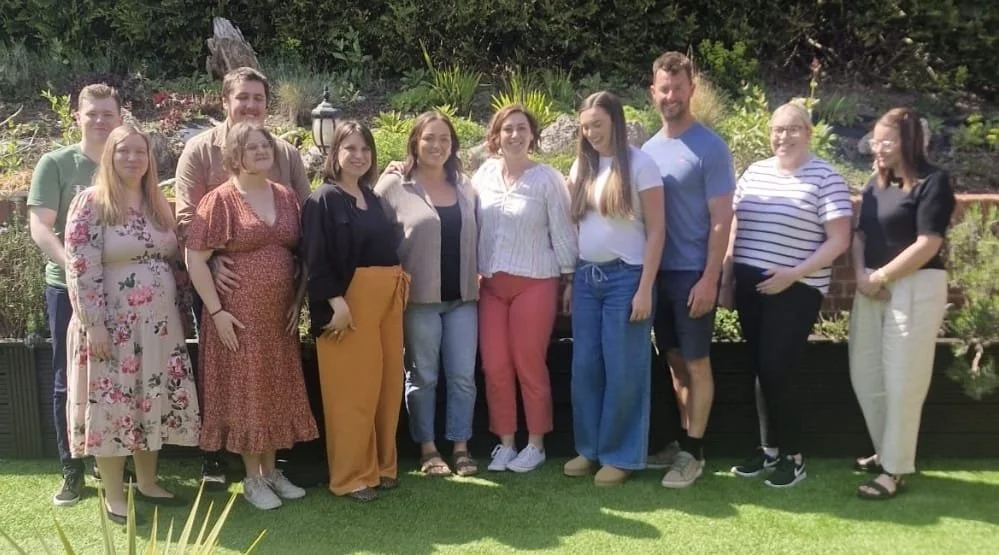 Paige standing outdoors with a group.