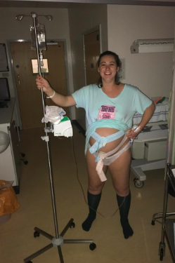 Paige standing beside a hospital bed during her first pregnancy.