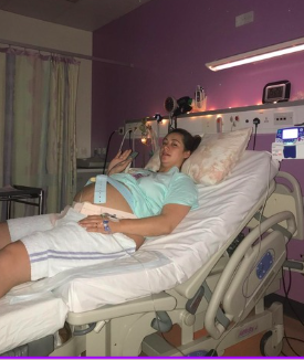 Paige resting in a hospital bed.