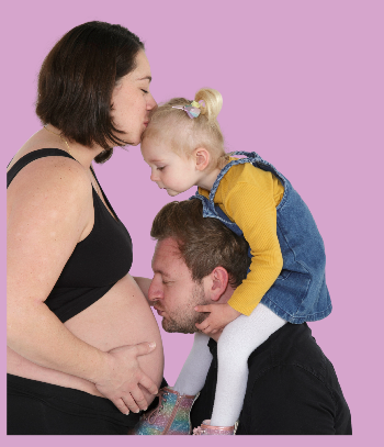 Paige with her husband and daughter during her second pregnancy.