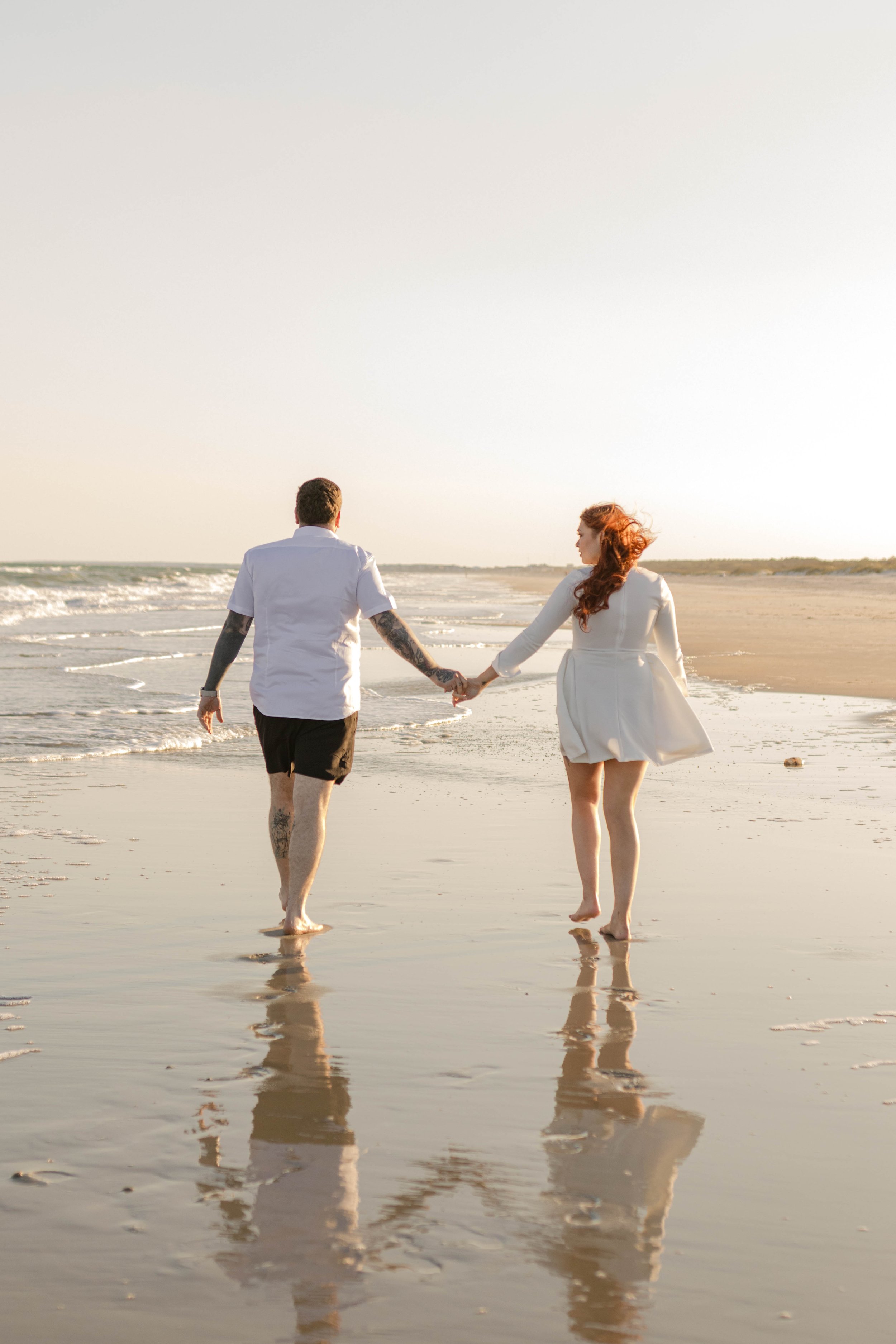 Creative couples portrait in dreamy golden light on Myrtle Beach shoreline