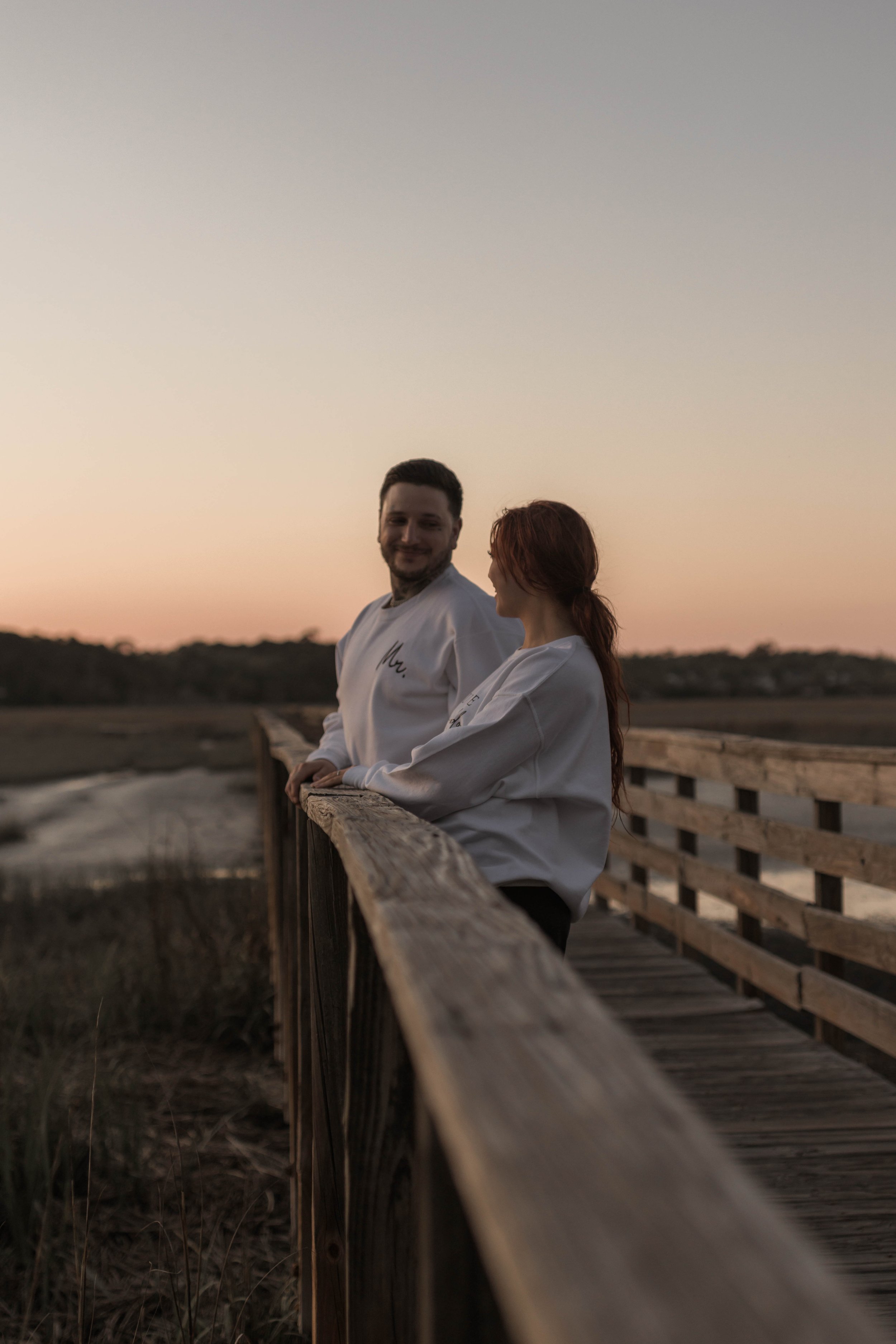 Creative couples portrait in dreamy golden light on Myrtle Beach shoreline