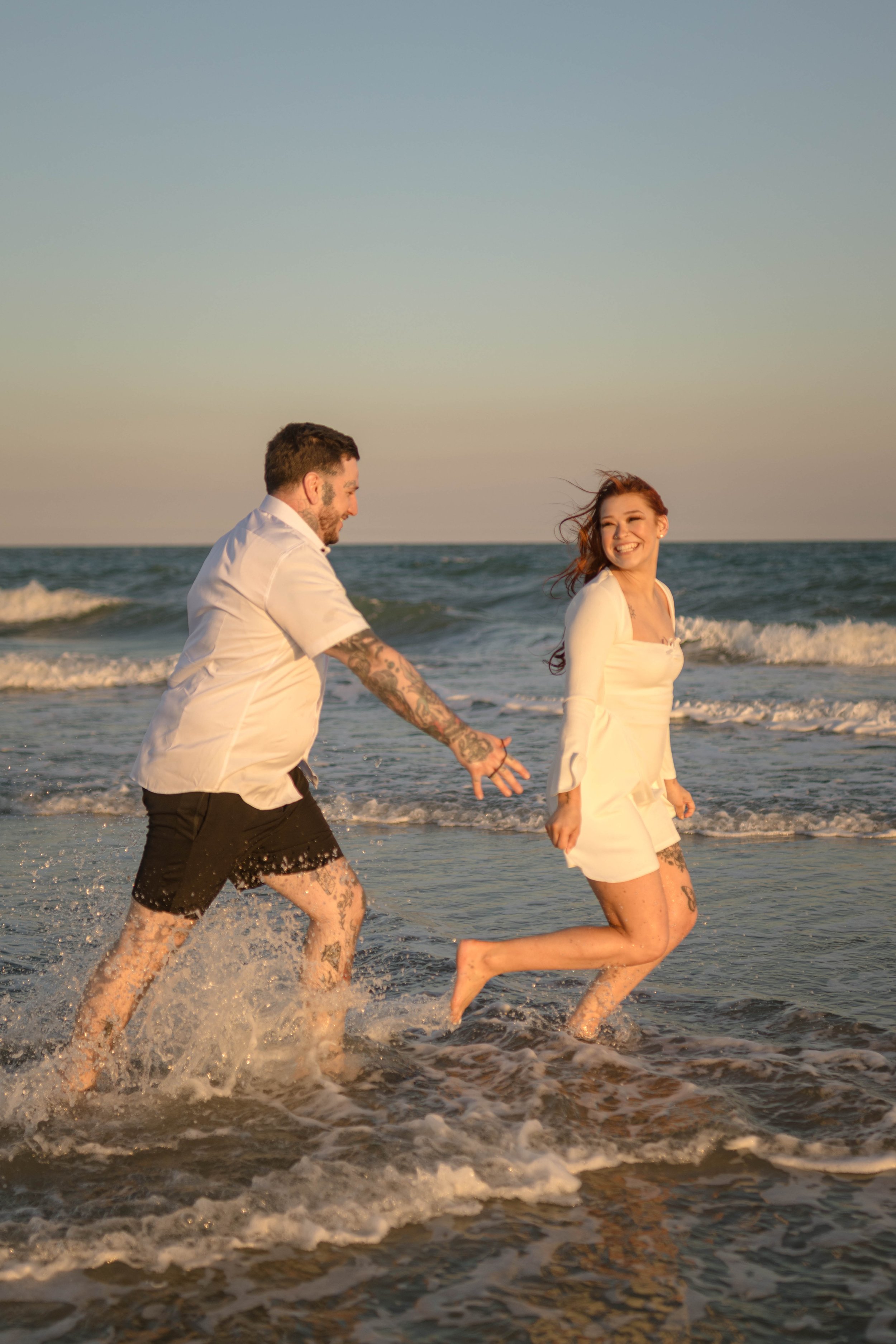 Creative couples portrait in dreamy golden light on Myrtle Beach shoreline