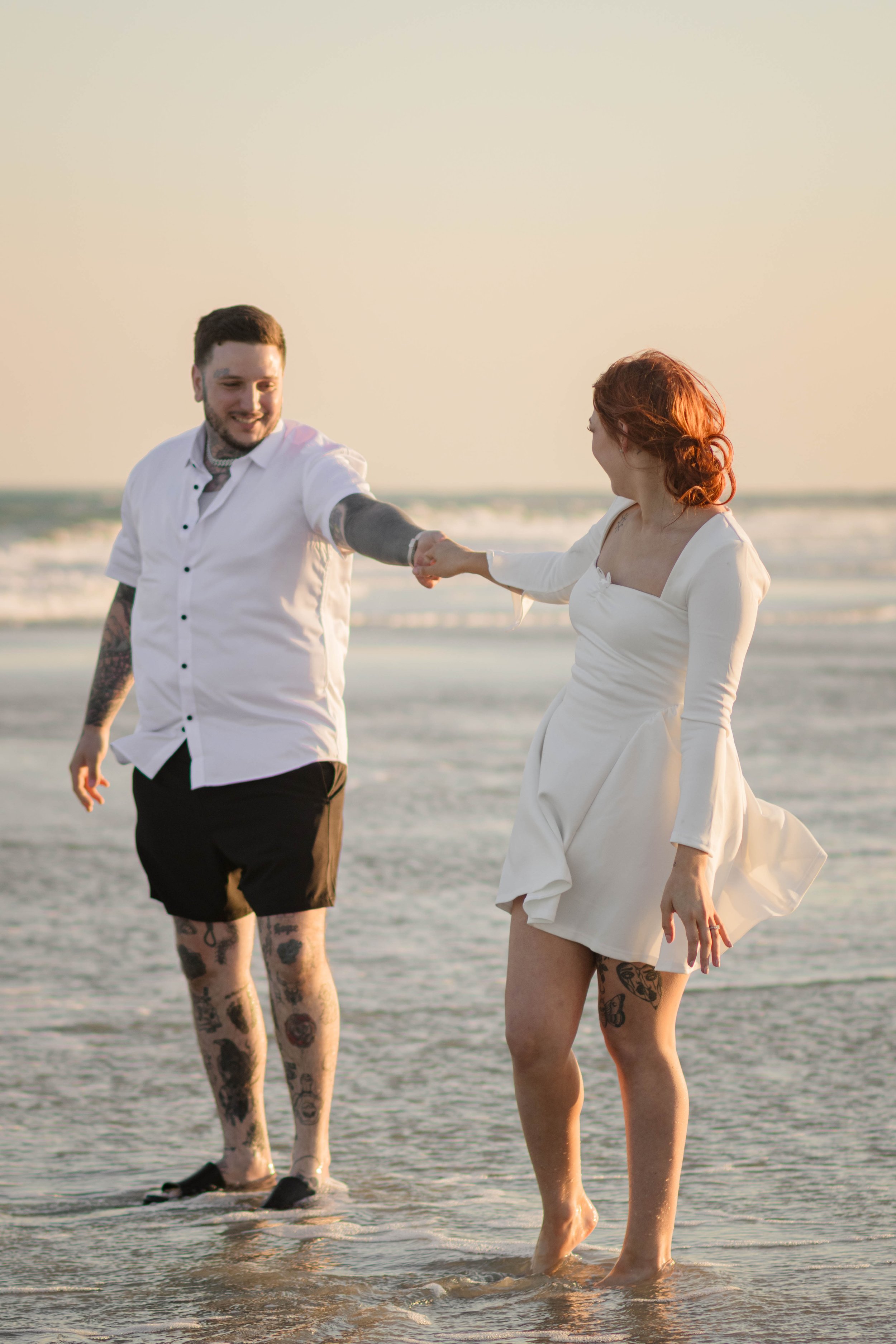 Creative couples portrait in dreamy golden light on Myrtle Beach shoreline