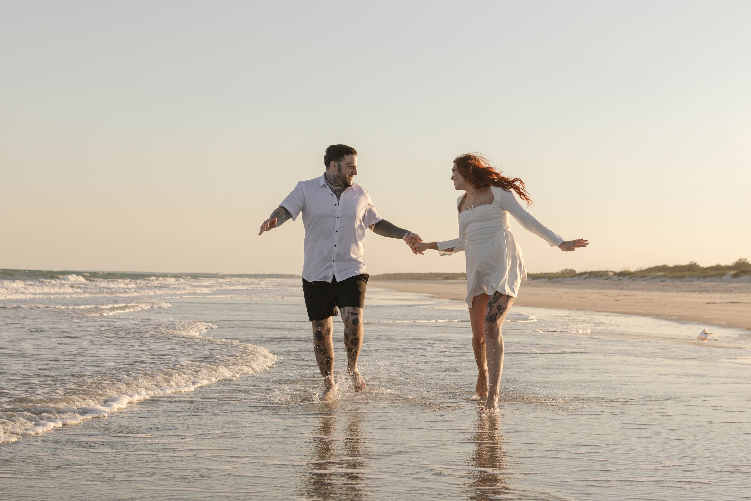 Creative couples portrait in dreamy golden light on Myrtle Beach shoreline