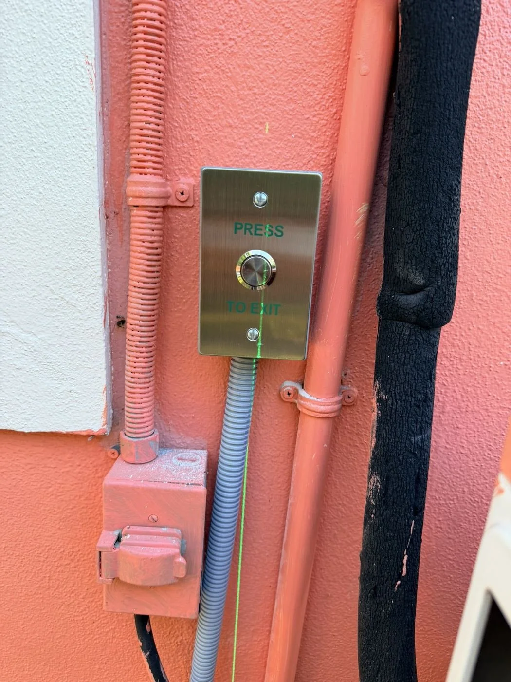 Stainless request-to-exit button with conduit, access control install