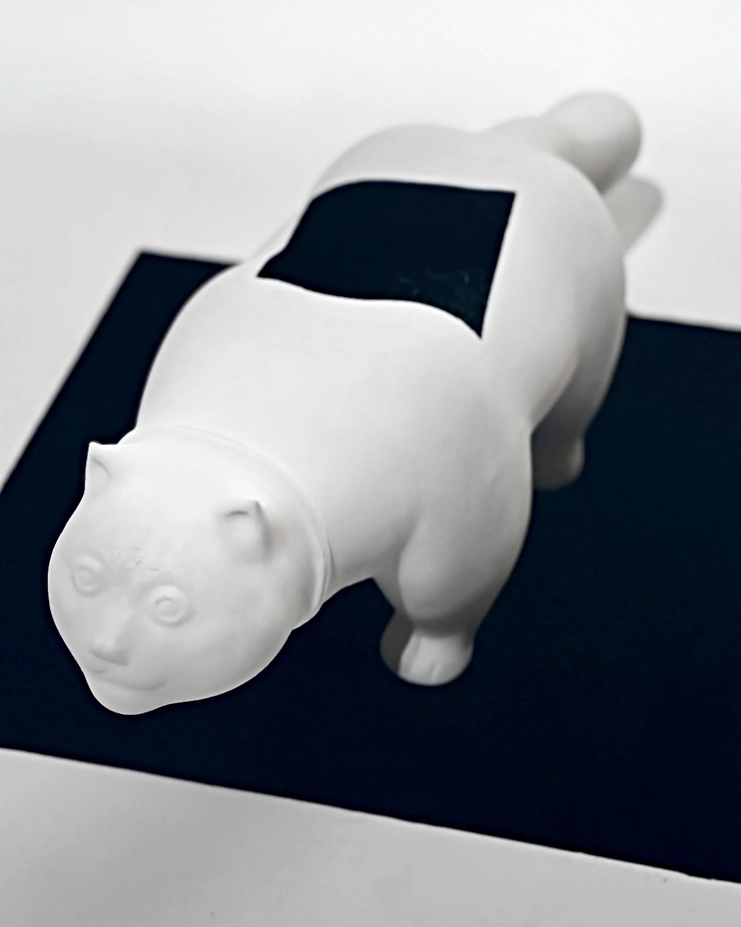 Modern sculptural reinterpretation of Fernando Botero’s iconic feline featuring a black spatial incision.