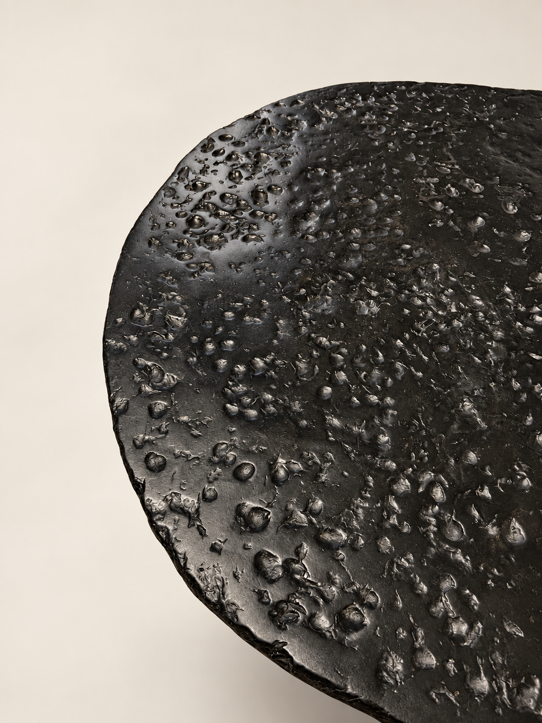 Close-up of the pitted, volcanic-like surface of Insula coffee table by Justino Del Casar