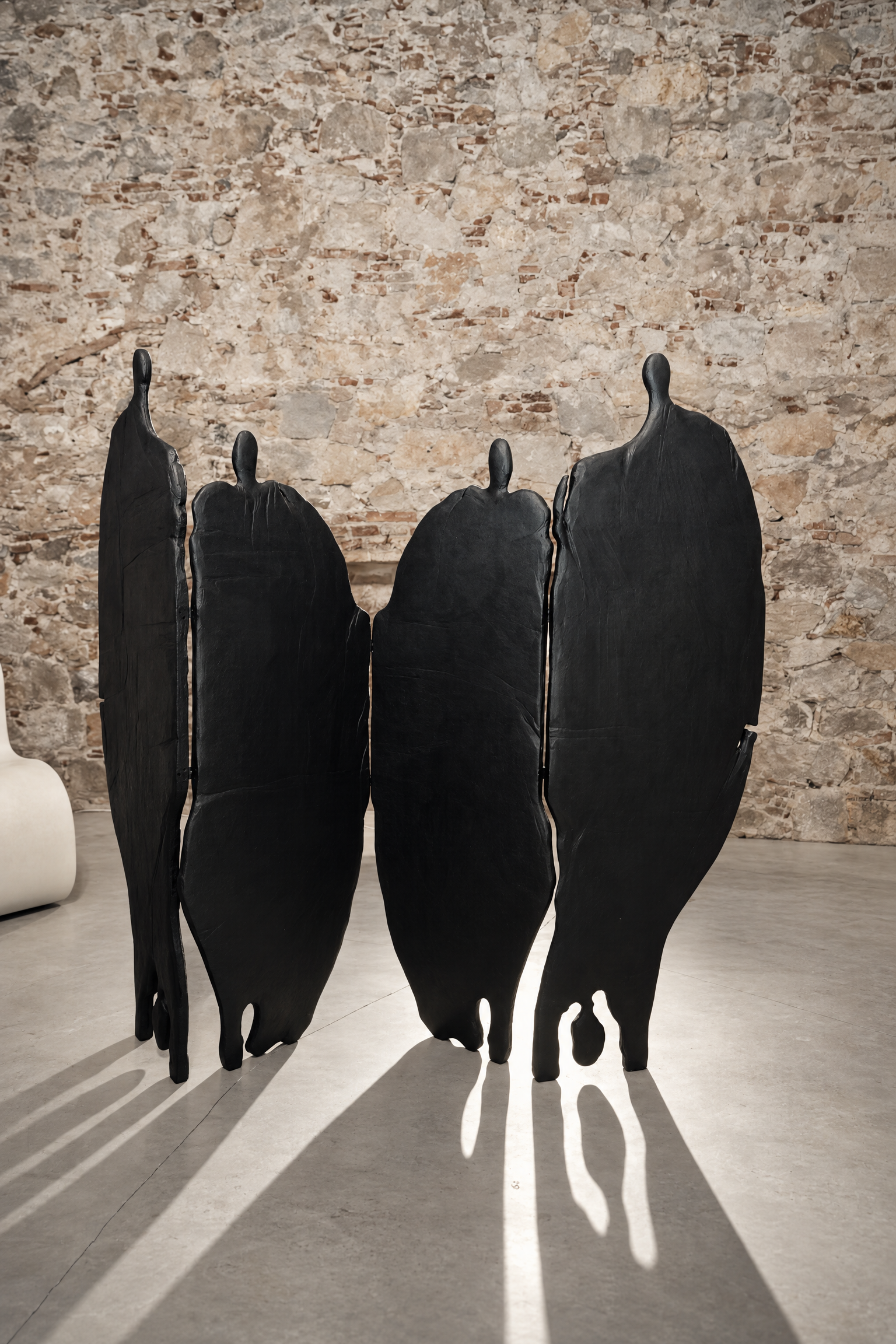 robert-pous-dark-figurative-sculptures-stone-wall.jpg