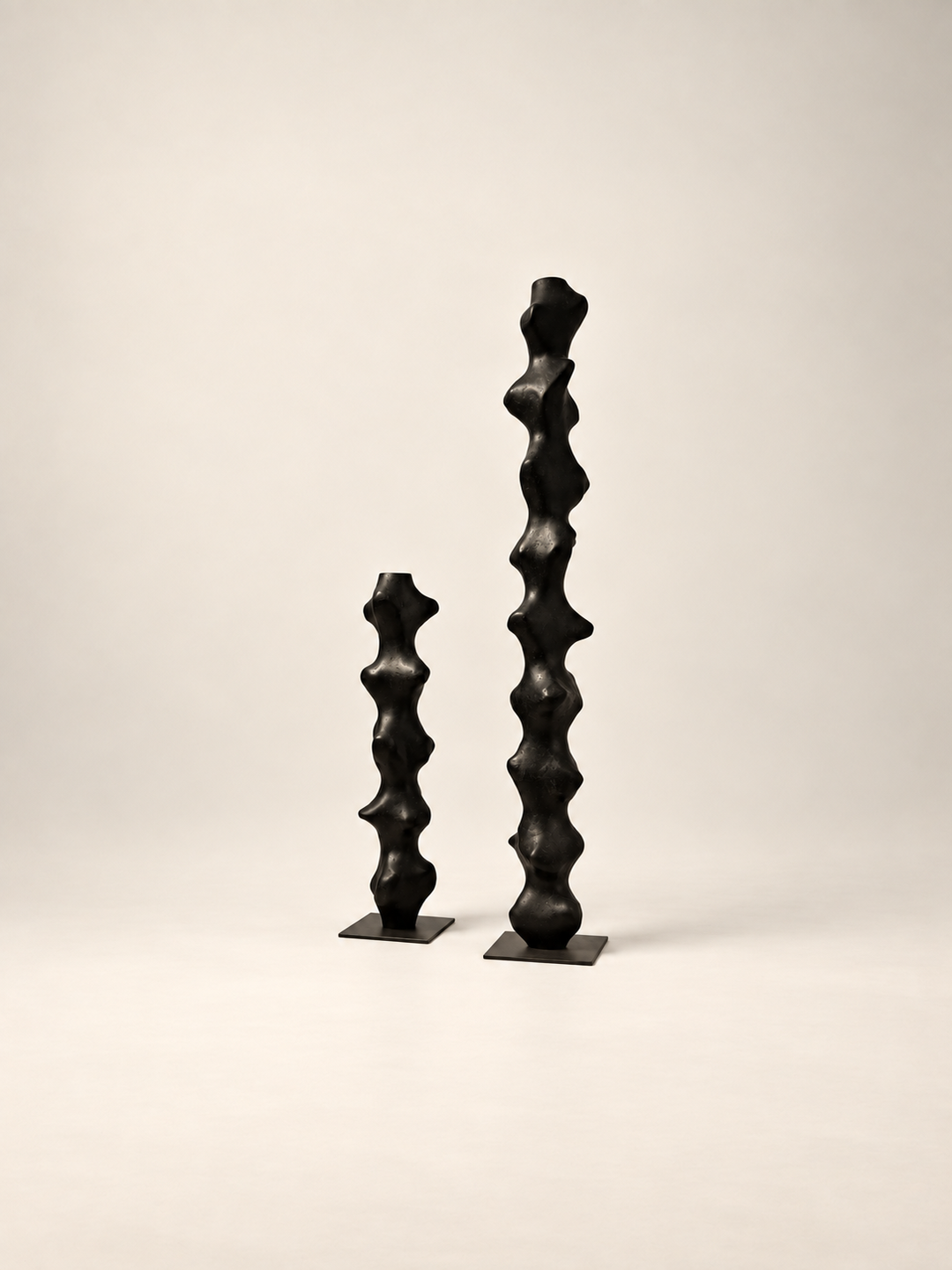 Tótem II by Justino Del Casar beside a smaller totem from the series, contemporary sculpture at BLANCONEGRO BARCELONA