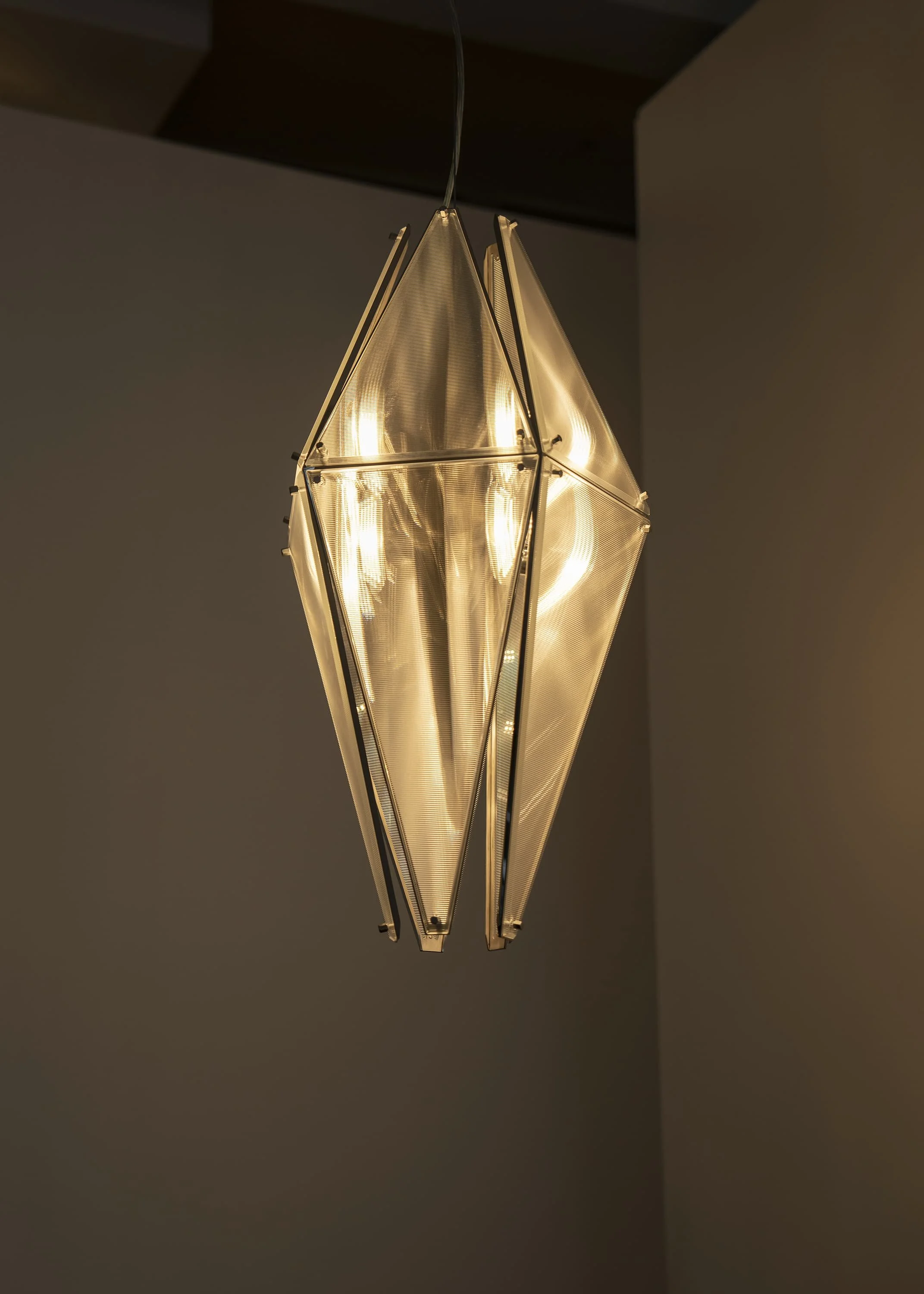 Contemporary lighting artwork by Sing Chan featuring folded translucent panels.