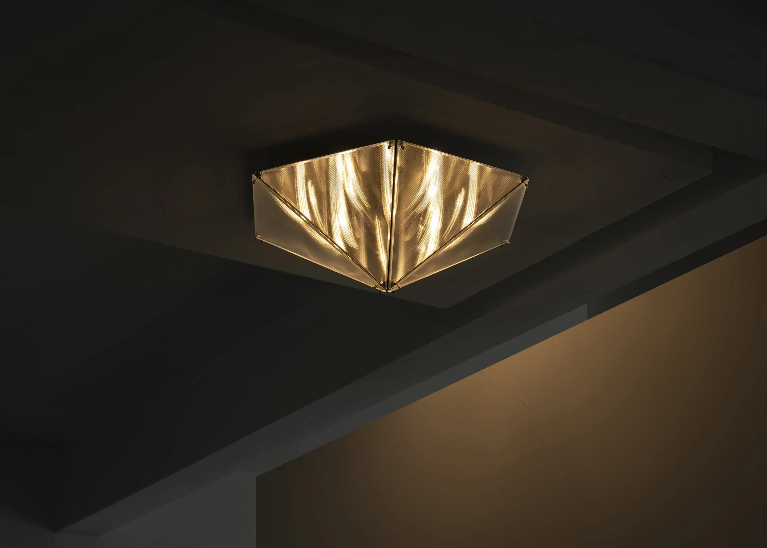 Designer ceiling lighting by Sing Chan combining structure, geometry and atmospheric glow.