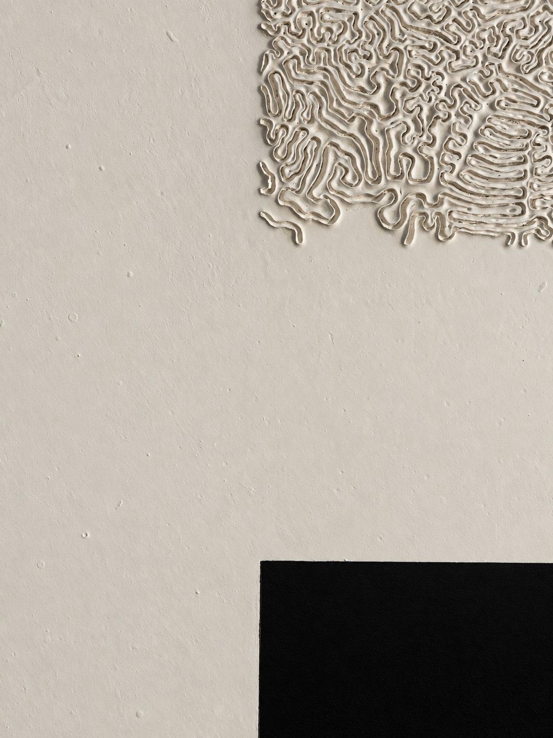 Oblique view of Black Flame by Robert Pous showing relief texture and a light-absorbing black void