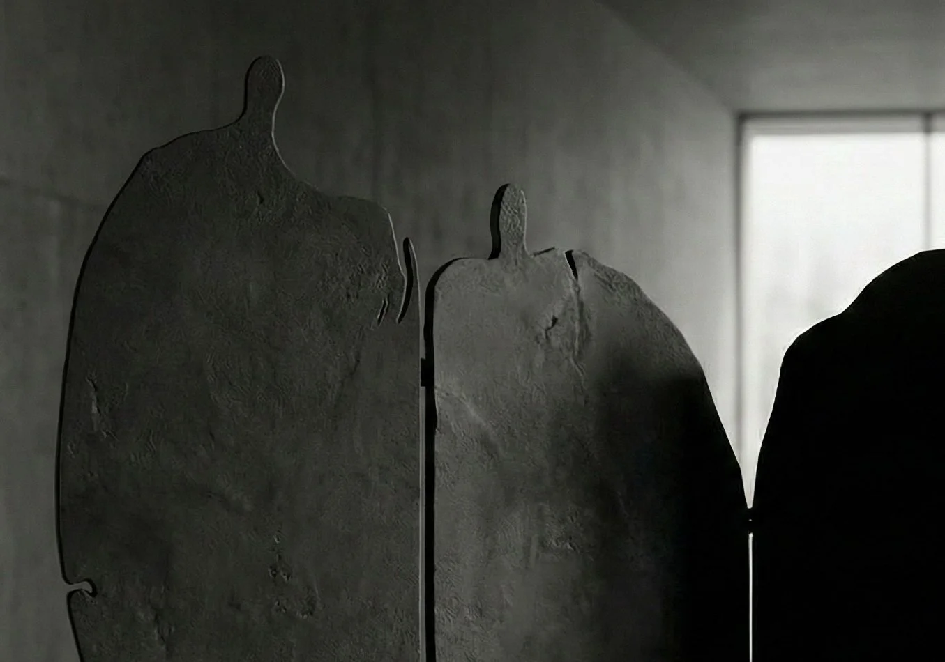 Functional sculpture folding screen with four human silhouettes