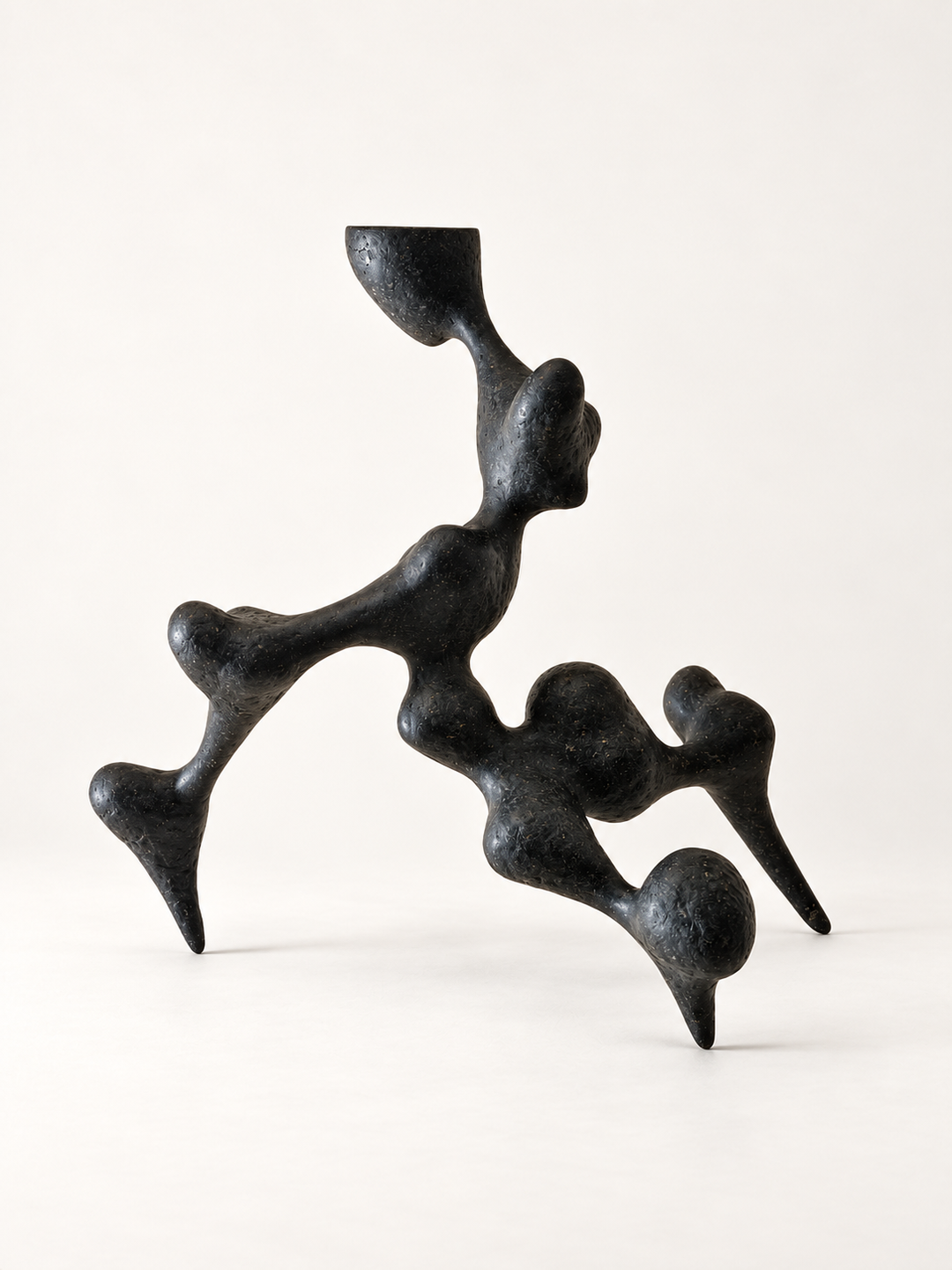 Side view of Bicho II by Justino Del Casar, a hand-modelled papier-mâché unique sculpture with tapered legs