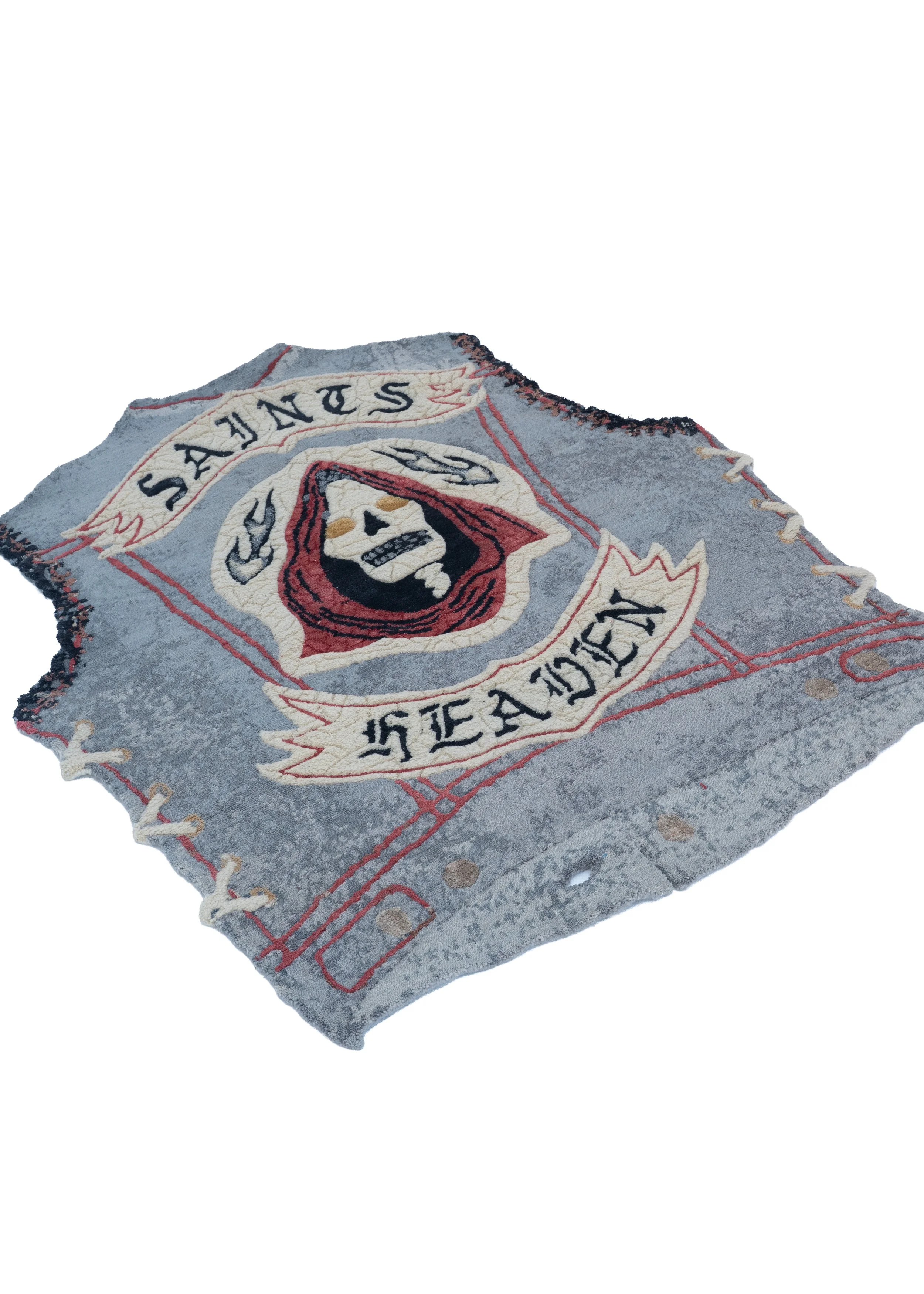 Shaped hand-knotted rug Saints by Julien Jaca: biker vest with Saints and Heaven gothic banners and laced sides, Dinodo Studio