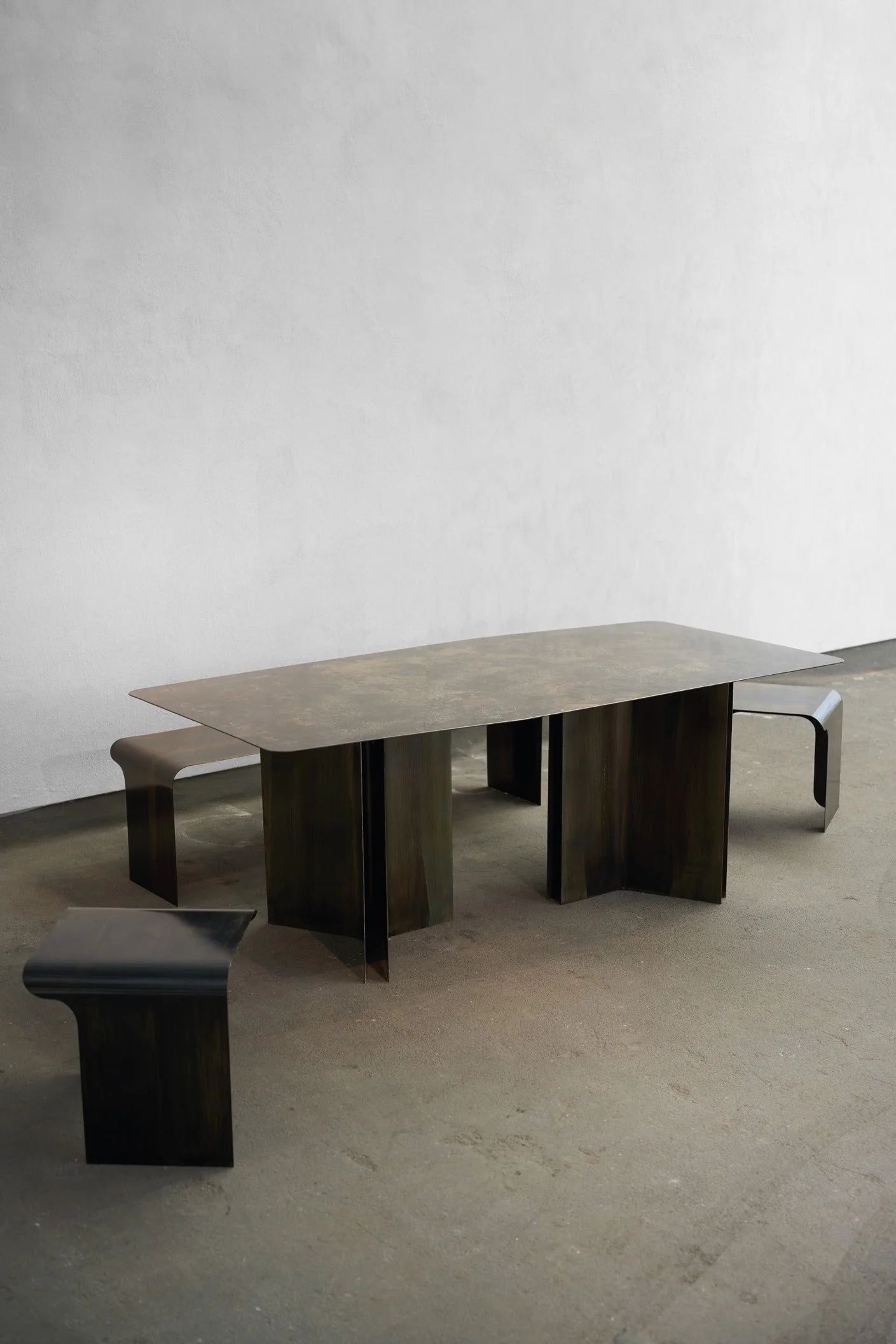 Sculptural contemporary dining table with architectural folded legs, Maxime Halot design