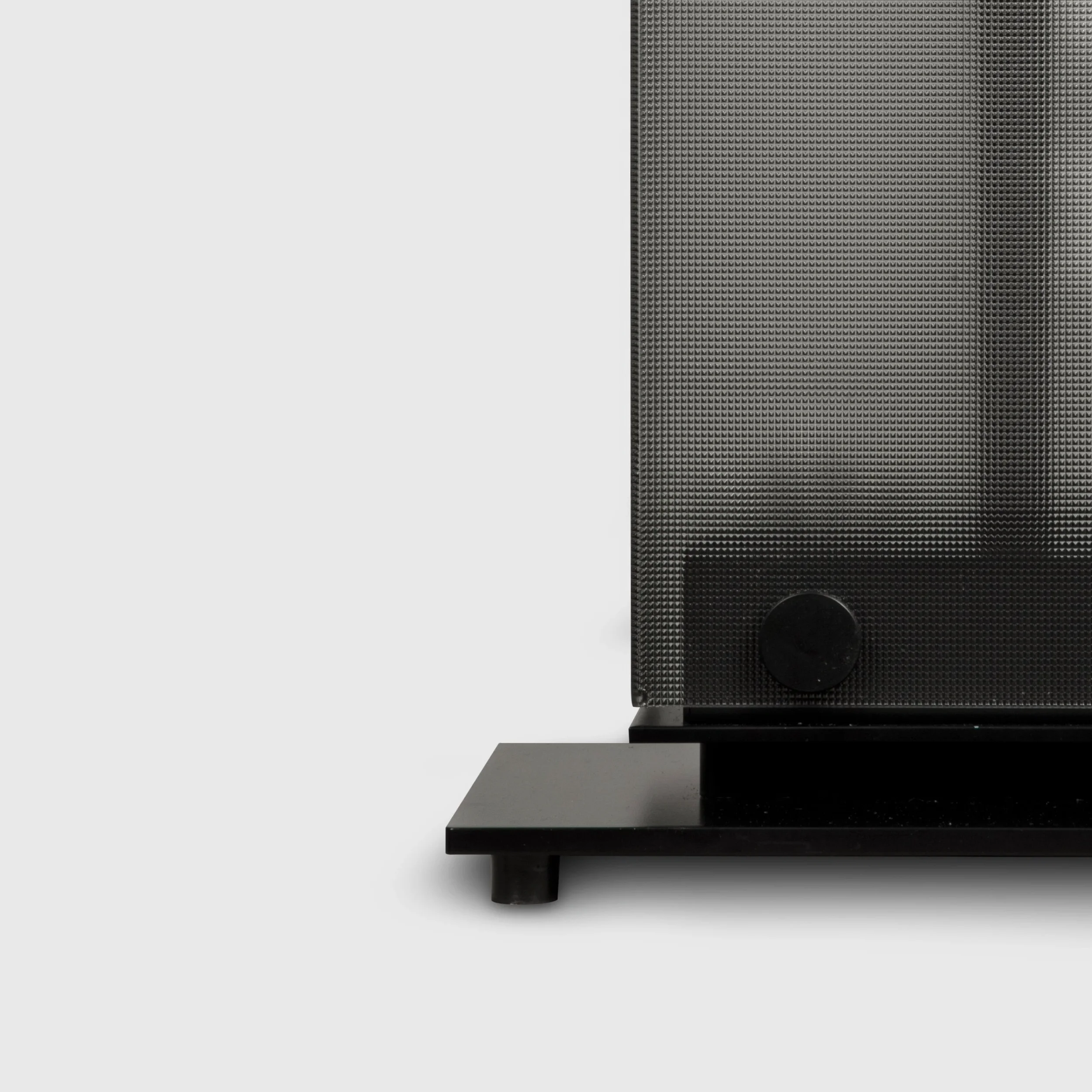 Close-up of the Belux Twilight floor lamp base in black, with structured glass texture and fixing knob