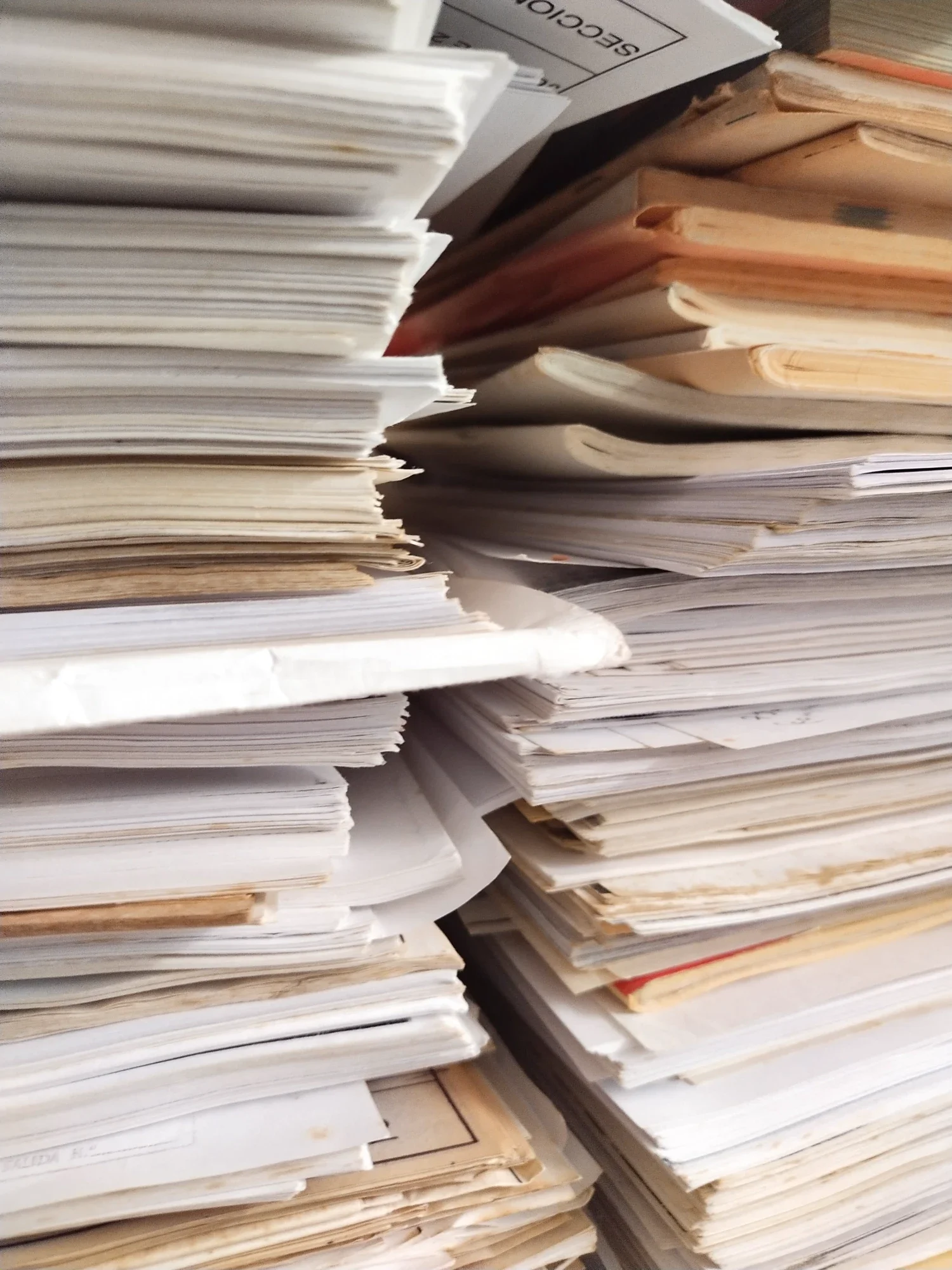 Stacks of discarded paper documents and old files, the raw material of Justino Del Casar's sculptures