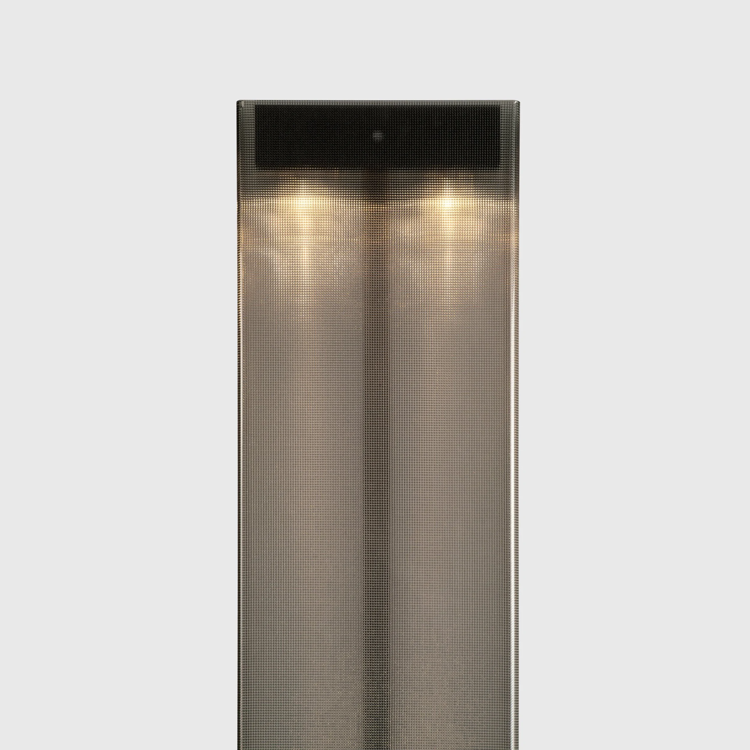 Top of the Belux Twilight floor lamp in black, warm LED light glowing through structured acrylic glass