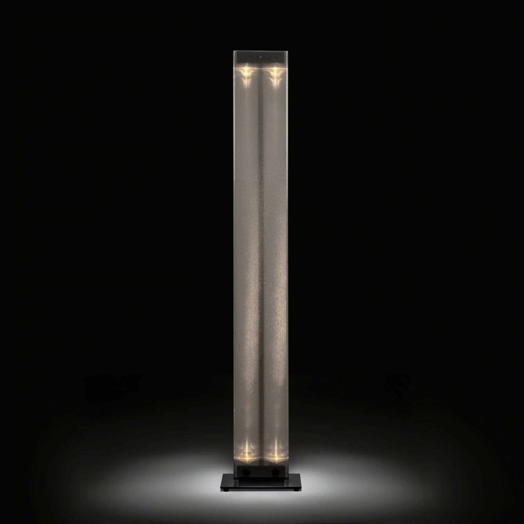 Belux Twilight floor lamp in black glowing in the dark, a sculptural column of light