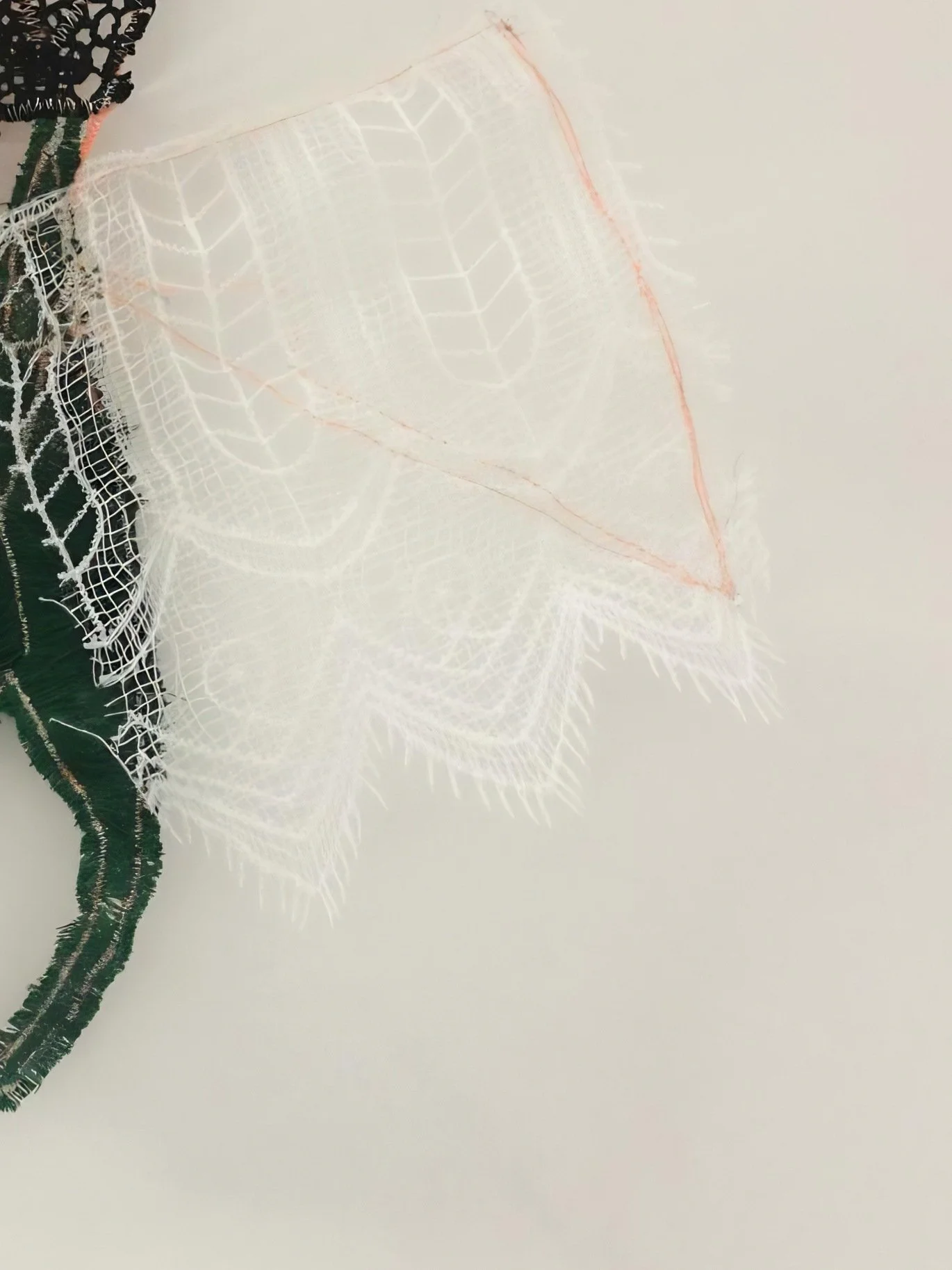 Mixed-media textile piece combining organza, thread and lace, part of a fiber art exhibition for luxury interiors.