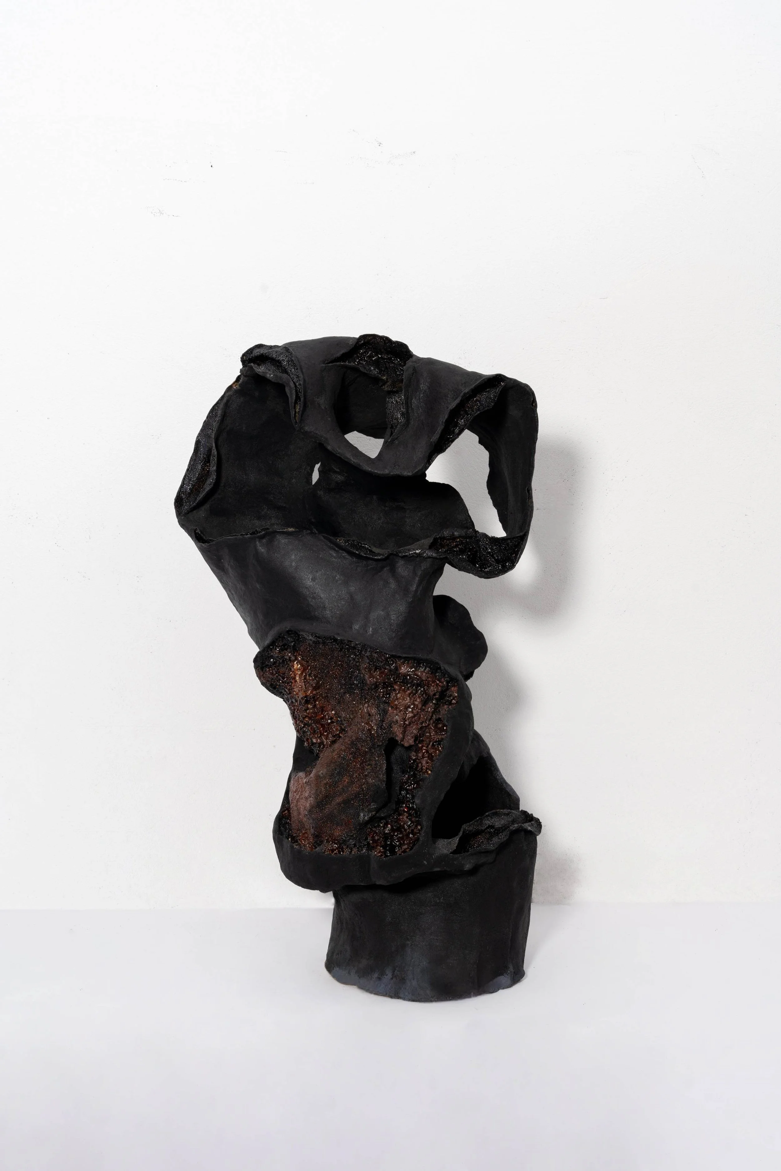 Contemporary lacquer sculpture with textured openings and charred surface by Liu Lijun