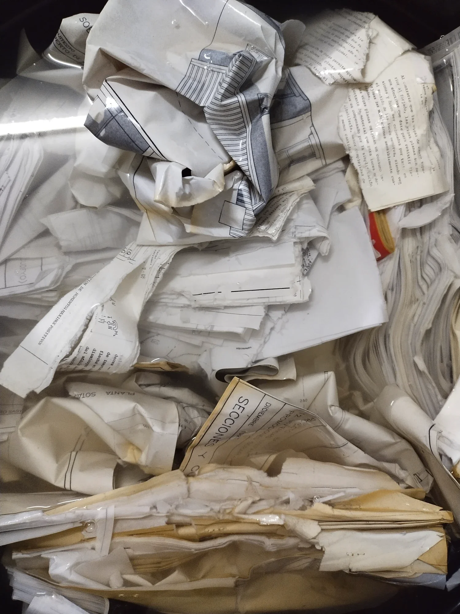 Crumpled, wet architectural plans and technical documents: discarded paper destined to become sculpture