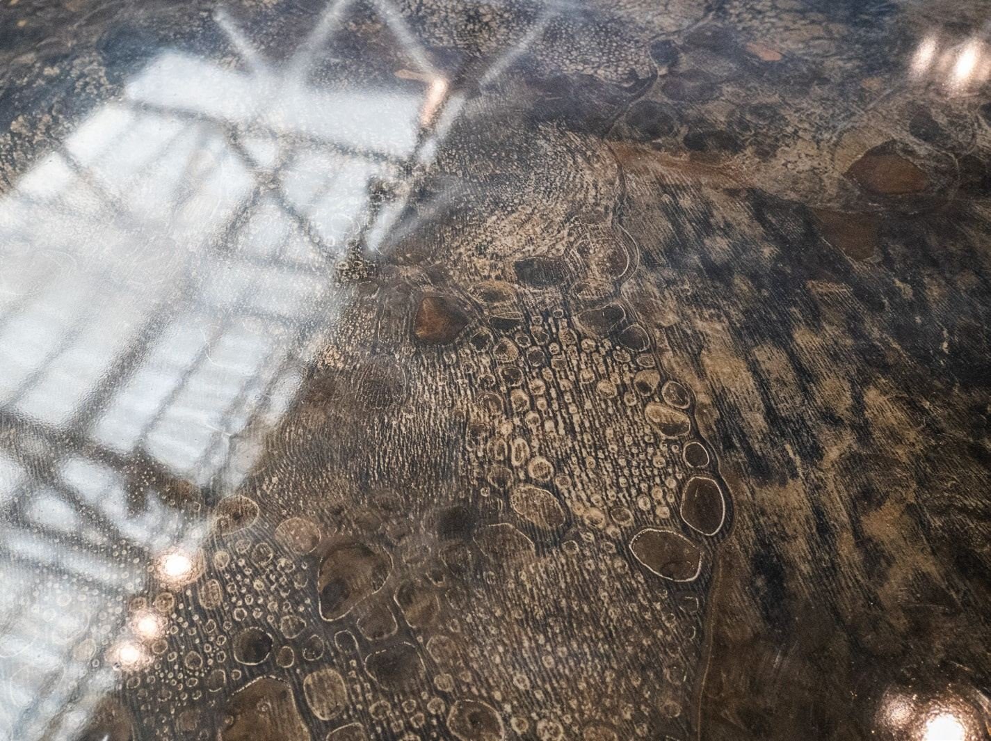 Patinated metal dining table with minimalist silhouette, collectible design furniture