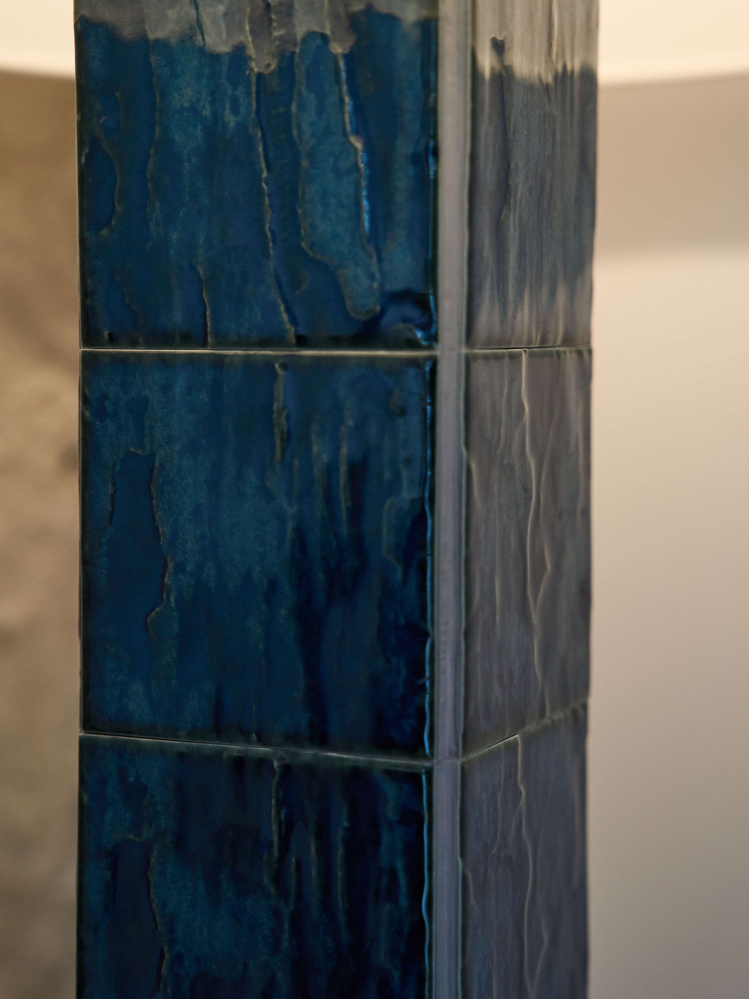 Collectible lighting design by ARTEMPO with textured blue ceramic base.
