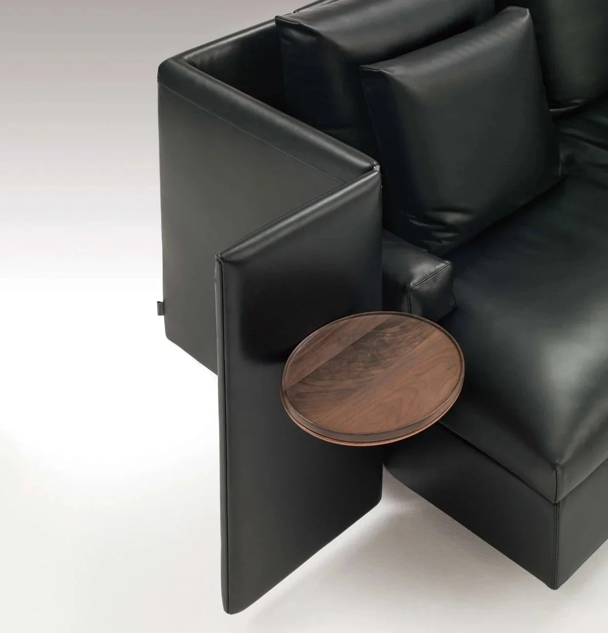 High-back modern sofa with configurable seating and mobile tray system.