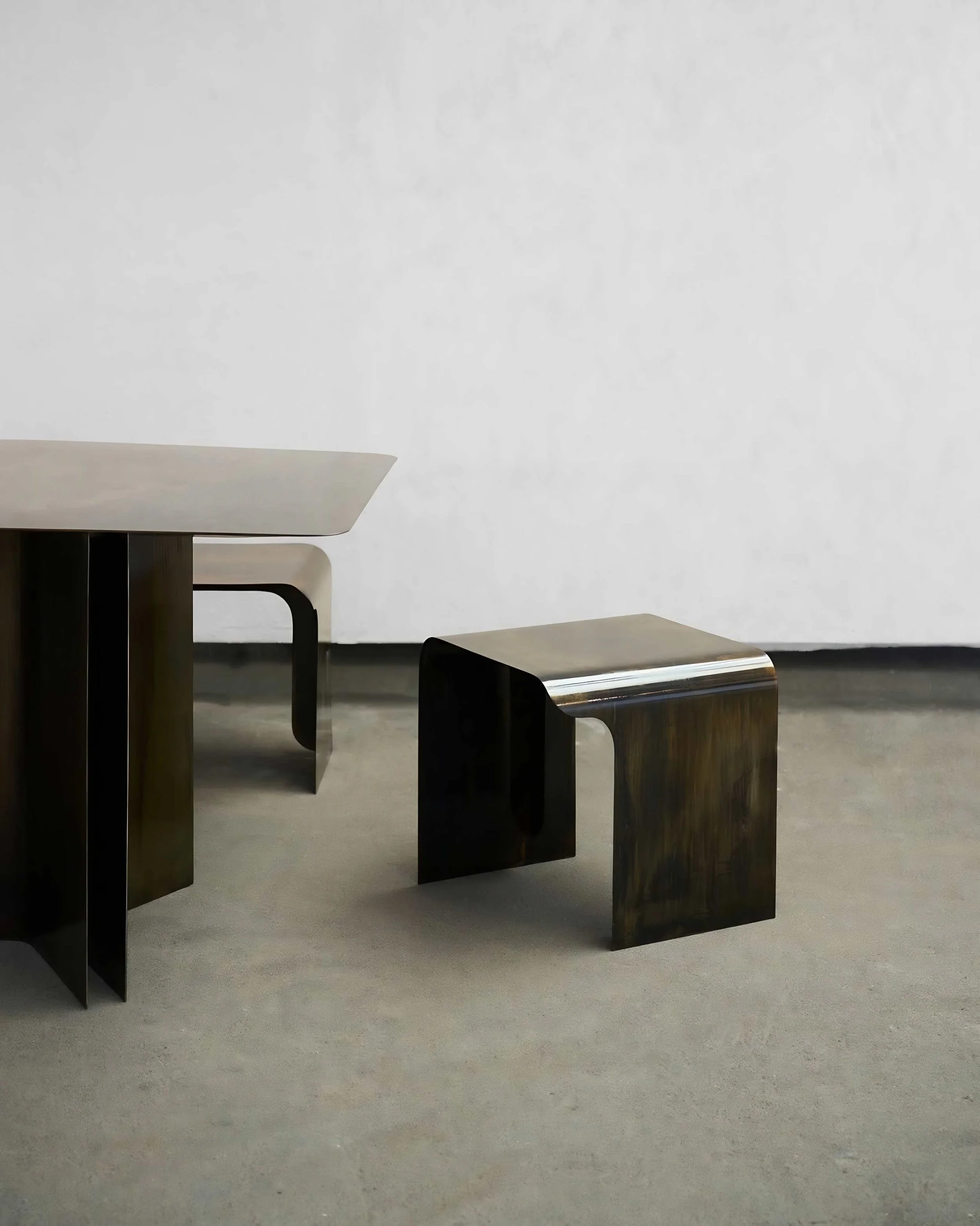 Art-design dining table with soft organic curves and monolithic presence — EAST WEST SPACE