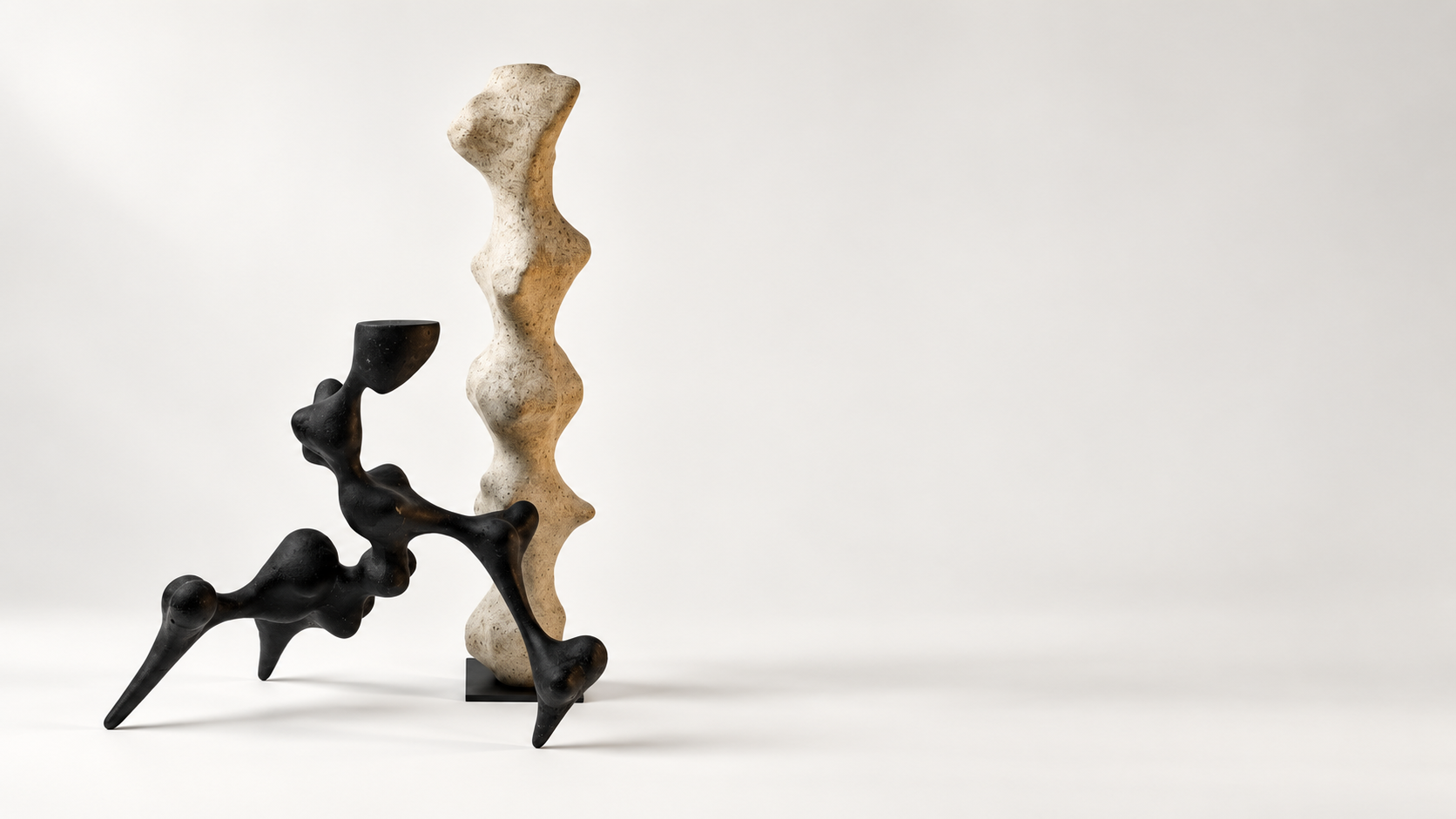 Pale recycled paper column beside a black organic branching sculpture with pointed feet, by Justino Del Casar in BLANCONEGRO Barcelona Art Gallery