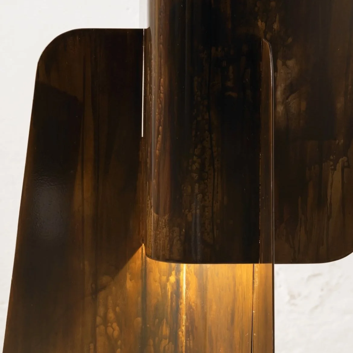 Artistic floor lamp with overlapping vertical panels and soft golden illumination, collectible lighting design.