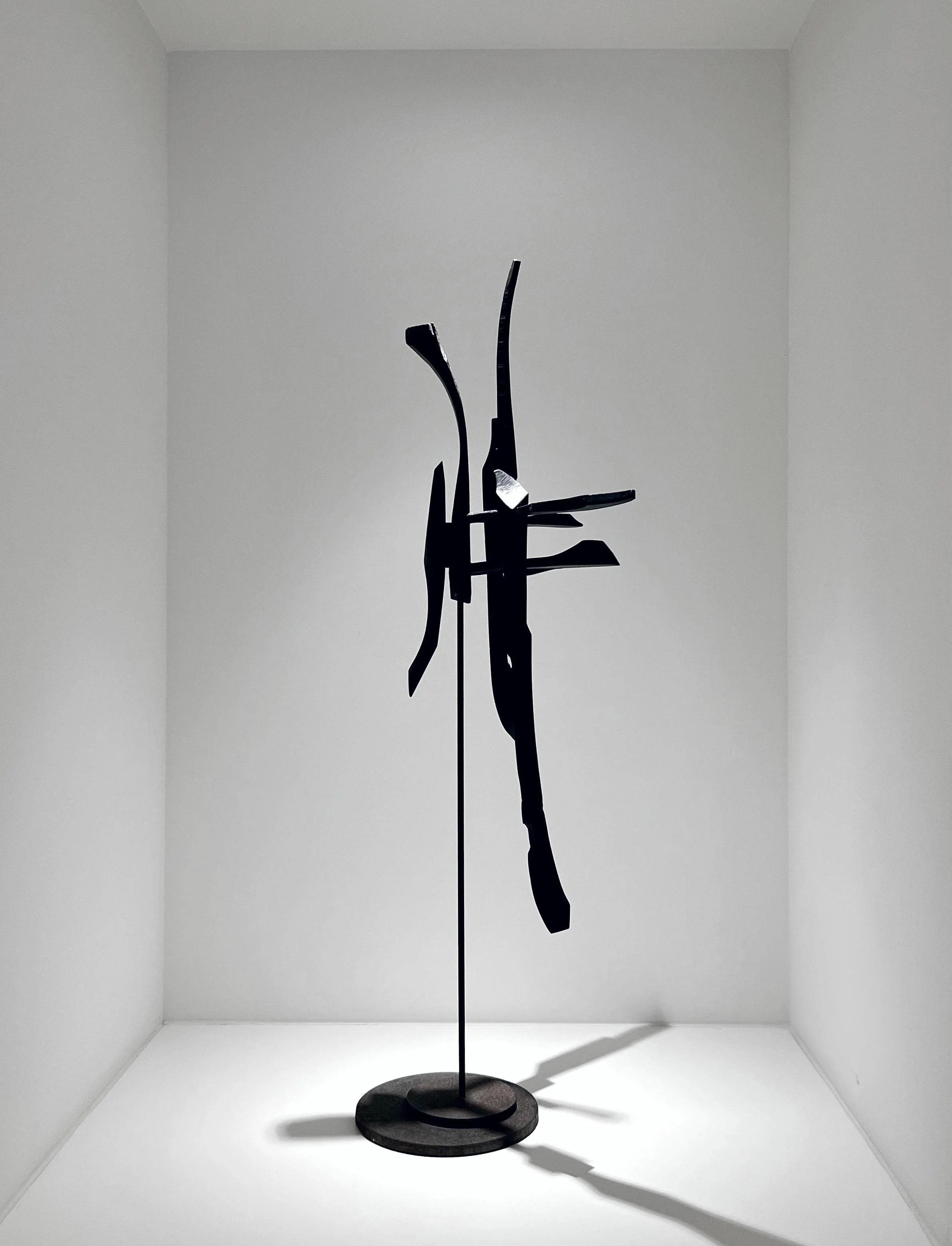 Compact contemporary sculpture in wood with directional carved pieces for curated spaces.