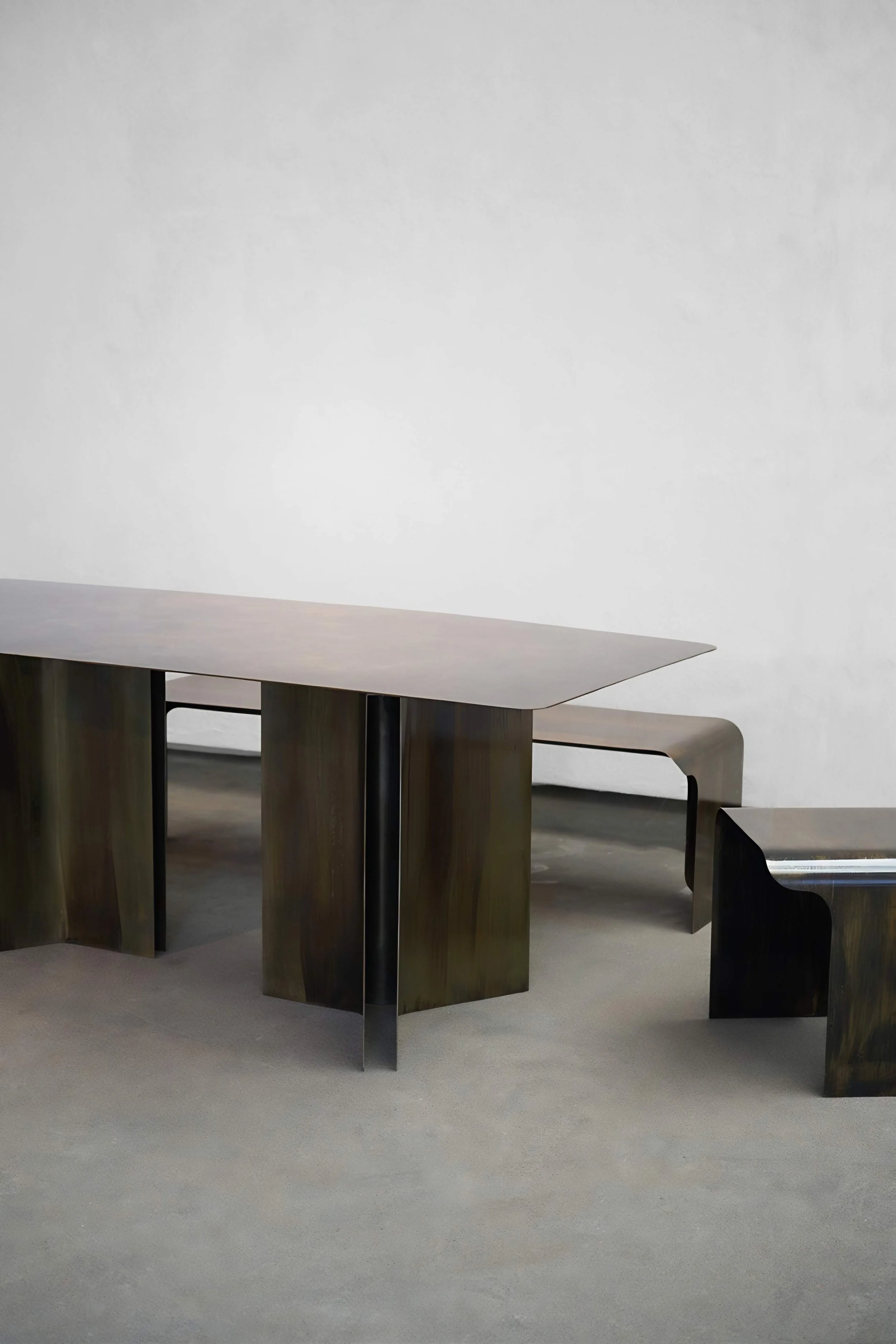 Handcrafted dining table in oxidized patinated metal by Maxime Halot, luxury collectible design
