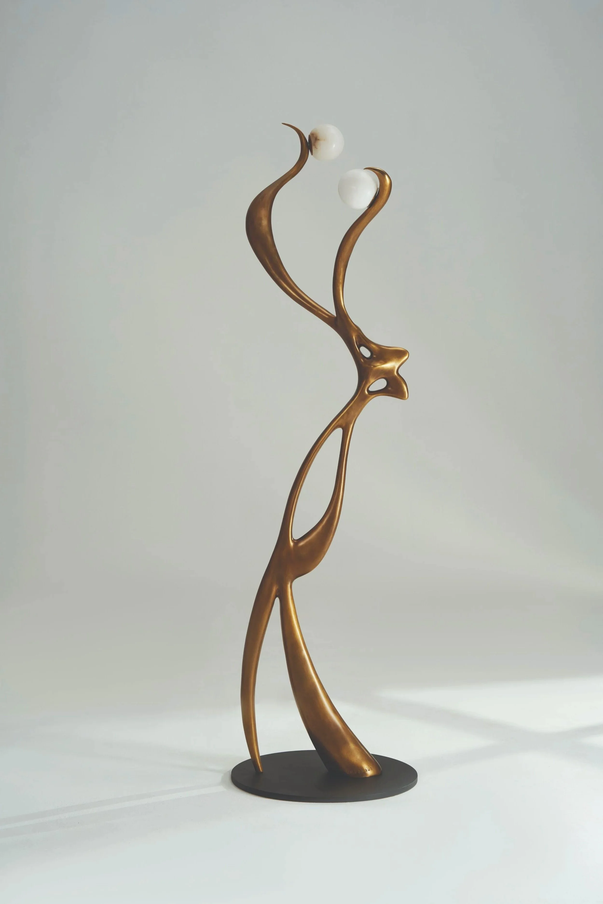 Sculptural floor lamp in bronze with dual globe lights, X Lampe – Elfe at EAST WEST SPACE.