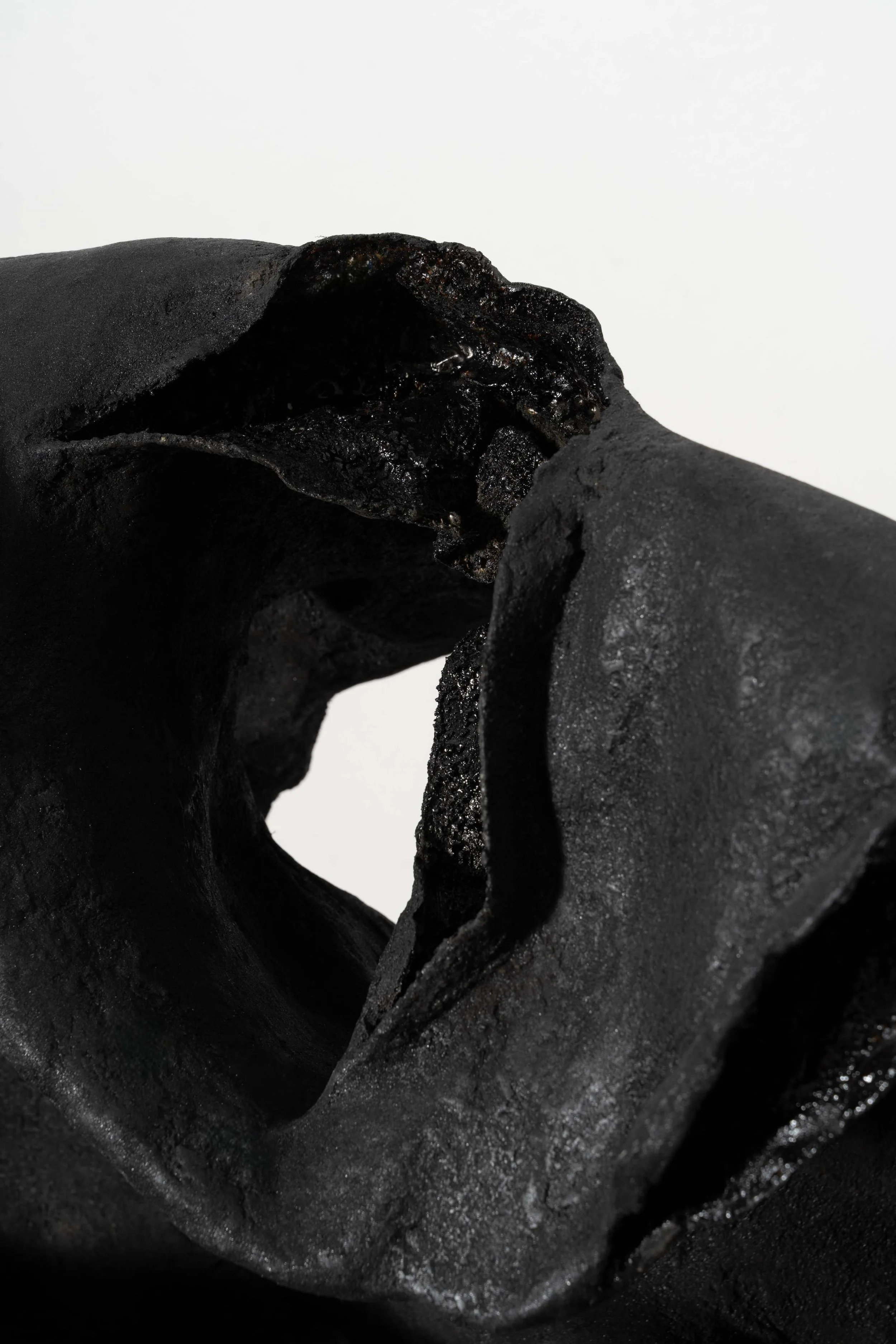 Abstract sculptural form in lacquer, ash, and ramie exploring erosion and tension