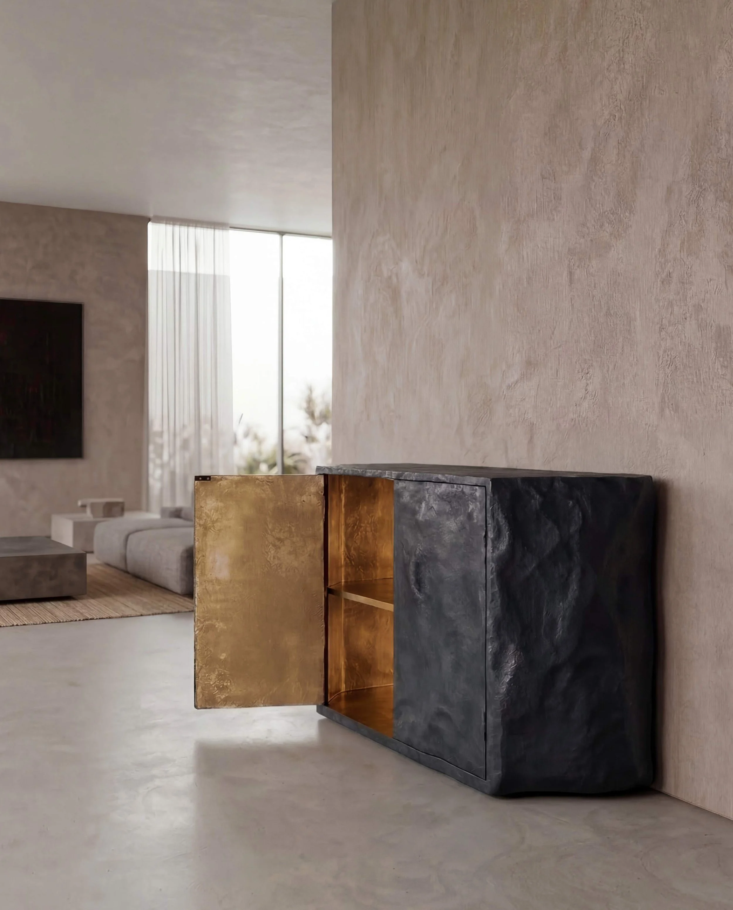Sculptural black lacquer cabinet with textured surface and gold interior