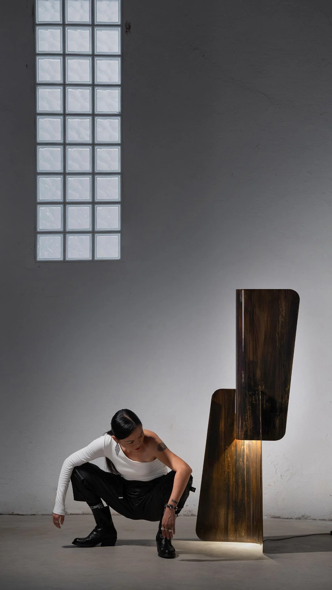 Contemporary collectible lamp with handcrafted oxidized surfaces and architectural composition.