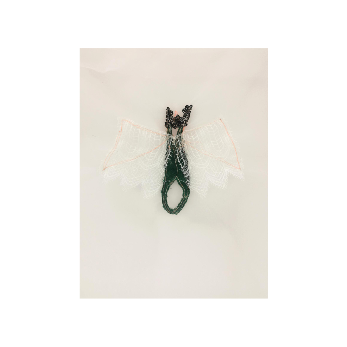 Contemporary textile sculpture with lace wings and fiber body exhibited at EAST WEST SPACE in Barcelona