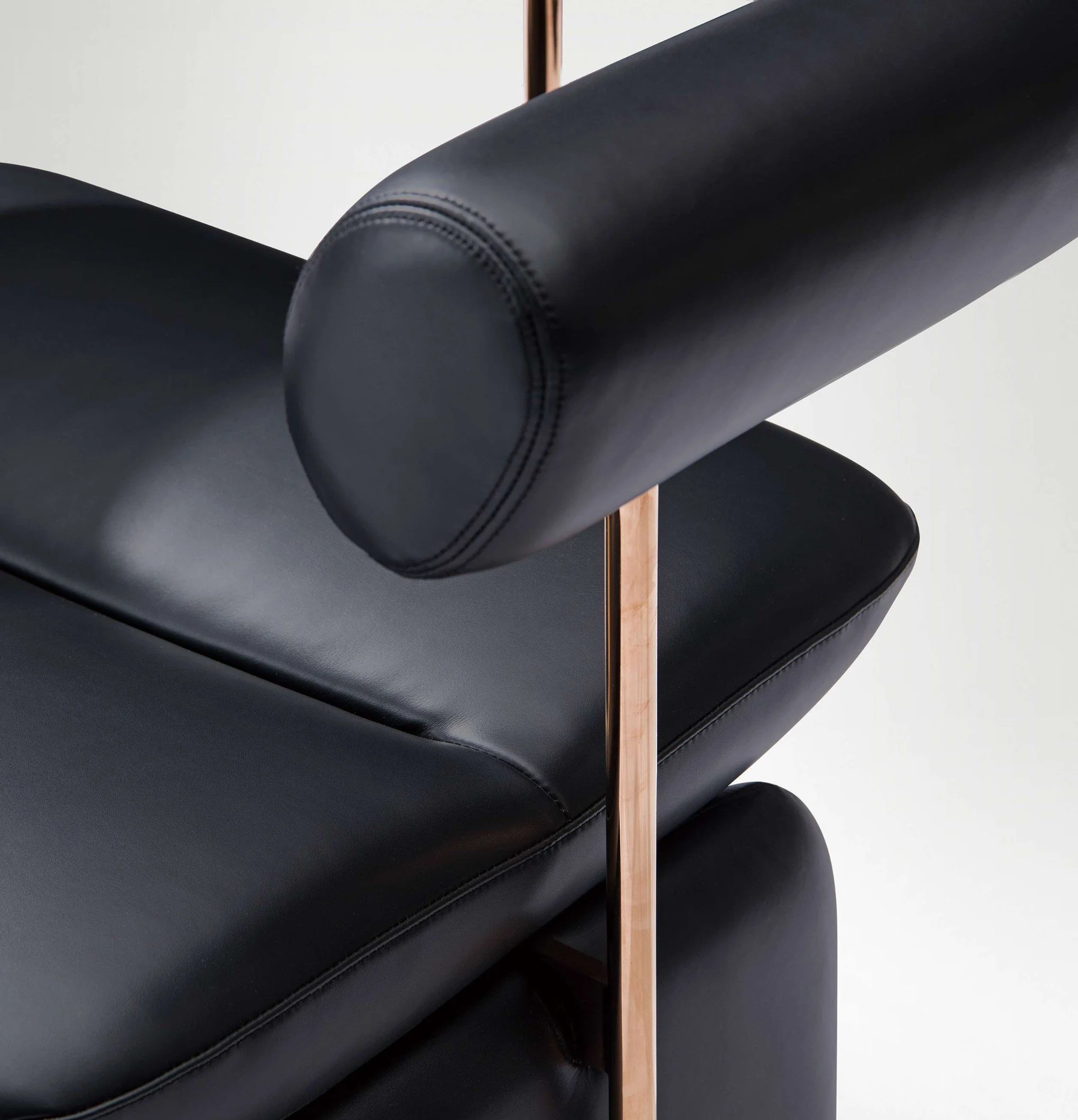 Collectible contemporary chair with metal columns and rounded leather forms.