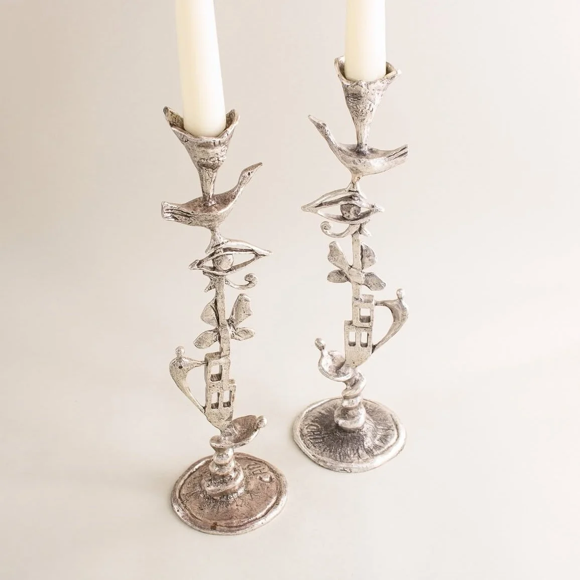 Artist-signed surrealist-style candle holders with figurative motifs by Corry Ammerlaan
