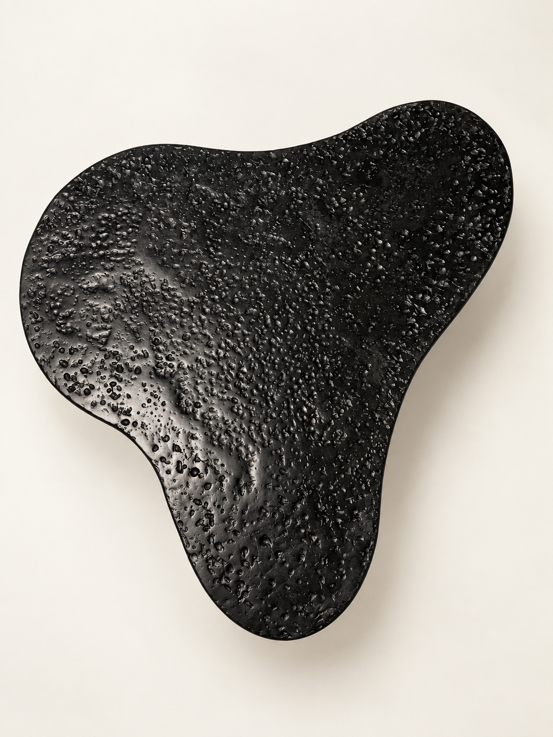 Top view of Insula, organic shaped coffee table by Justino Del Casar in black recycled paper